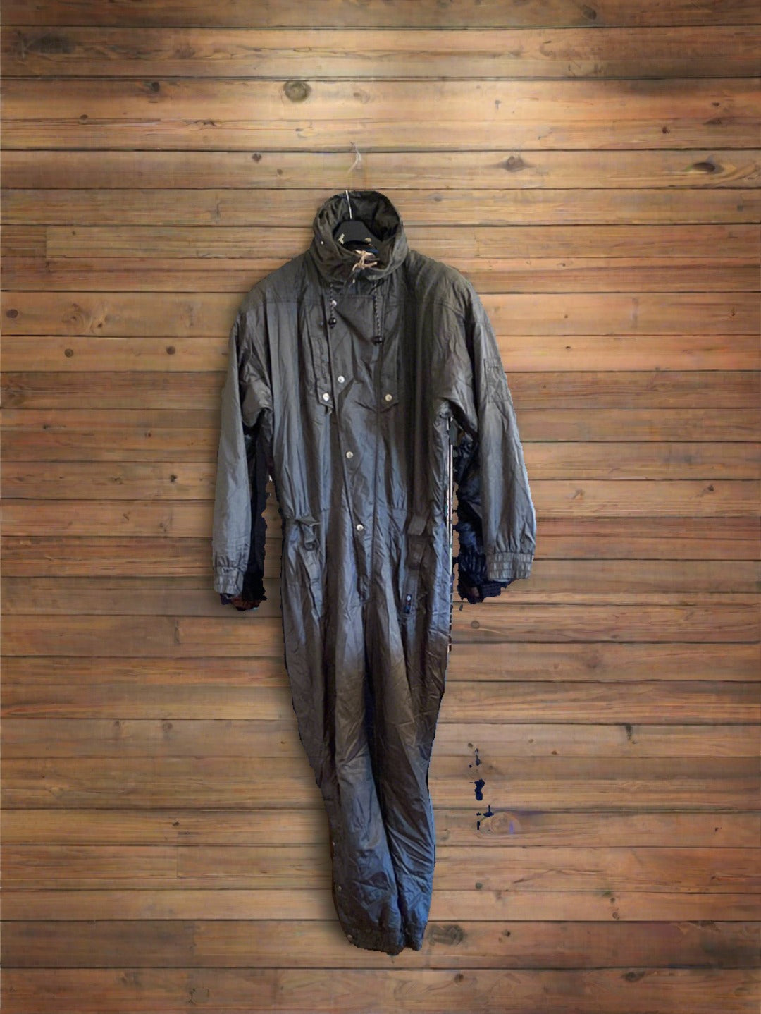 Dark Olive Green Couloir 1-piece ski suit, front view, on wood wall