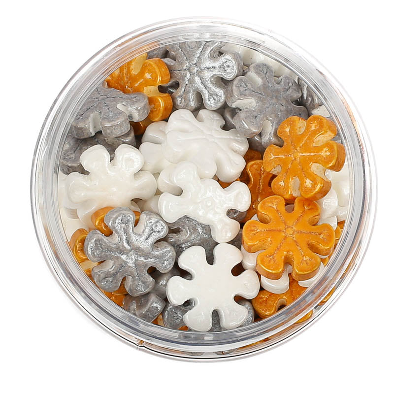 Image of a container of white, silver & gold snowflake shaped sprinkles for cake or cookie decorating viewed from the top