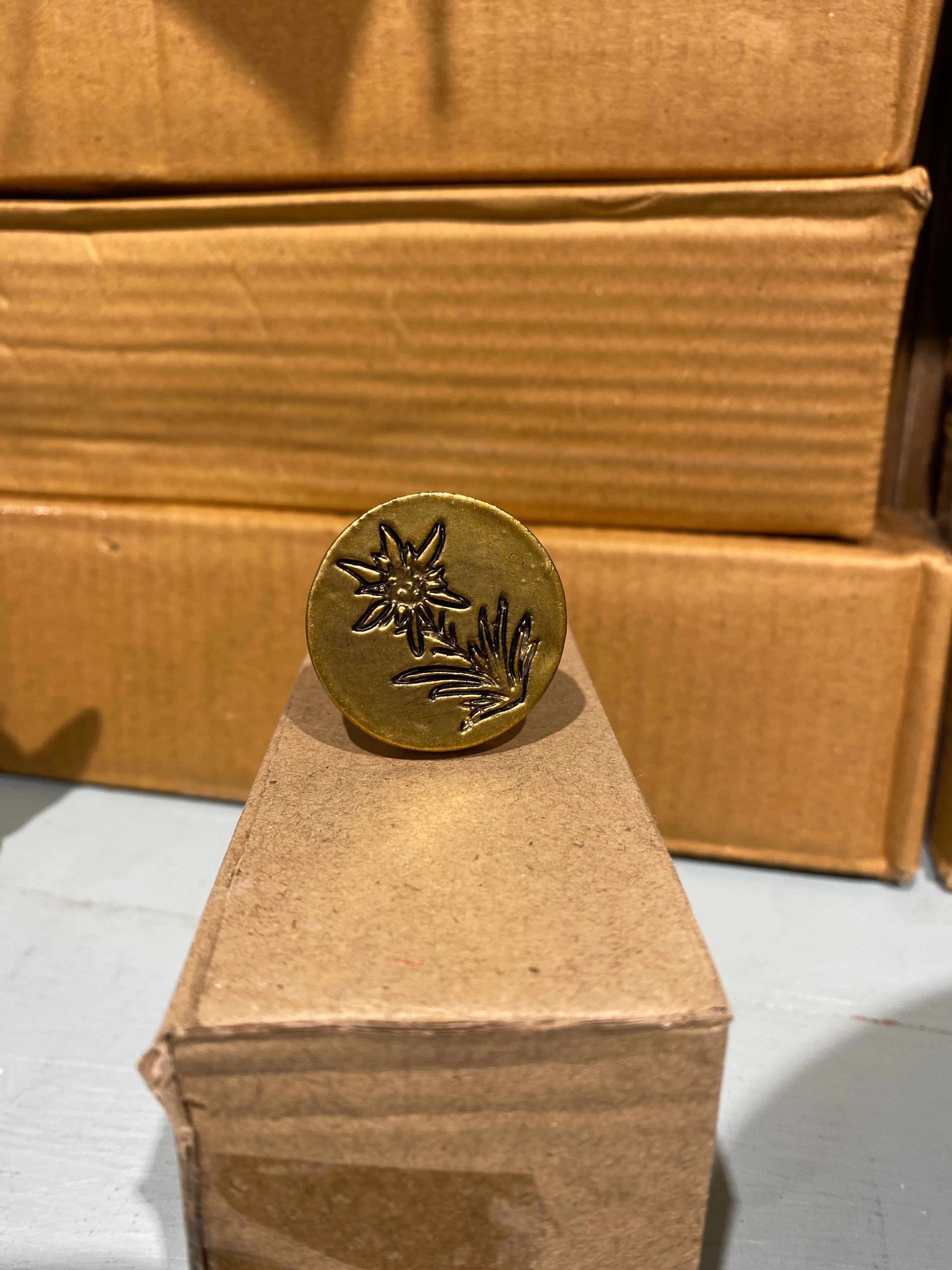 Brass Edelweiss flower drawer knob with lush leaves at base