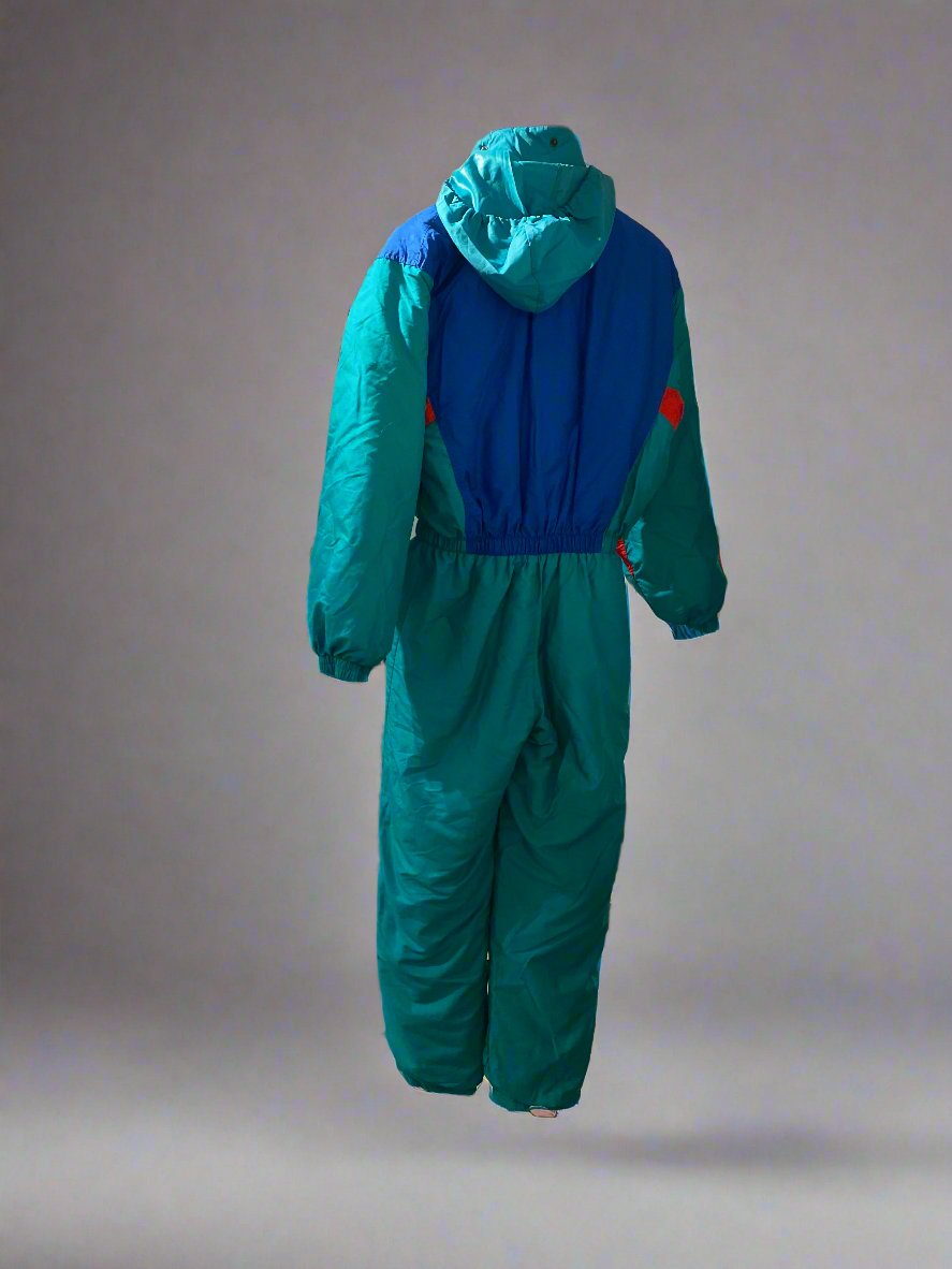 Vintage SKISS green, blue and red one-piece snow suit with an embroidered fabric patch on the left hand side of the chest, a fold away into the collar hood, and pockets on either side of the hips. Rear, showing unfolded hood