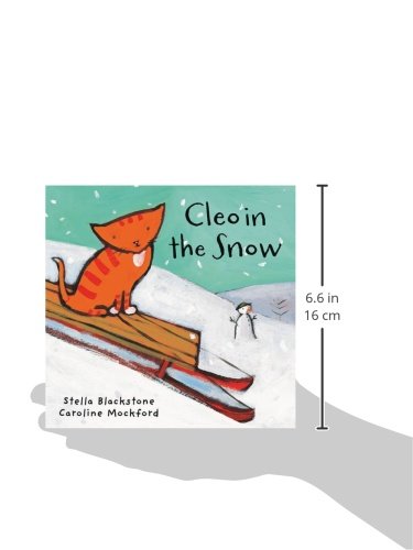Book image: Cleo in the snow showing an orange cat riding a toboggan on a snowy hill. Book against white background & showing book dimensions