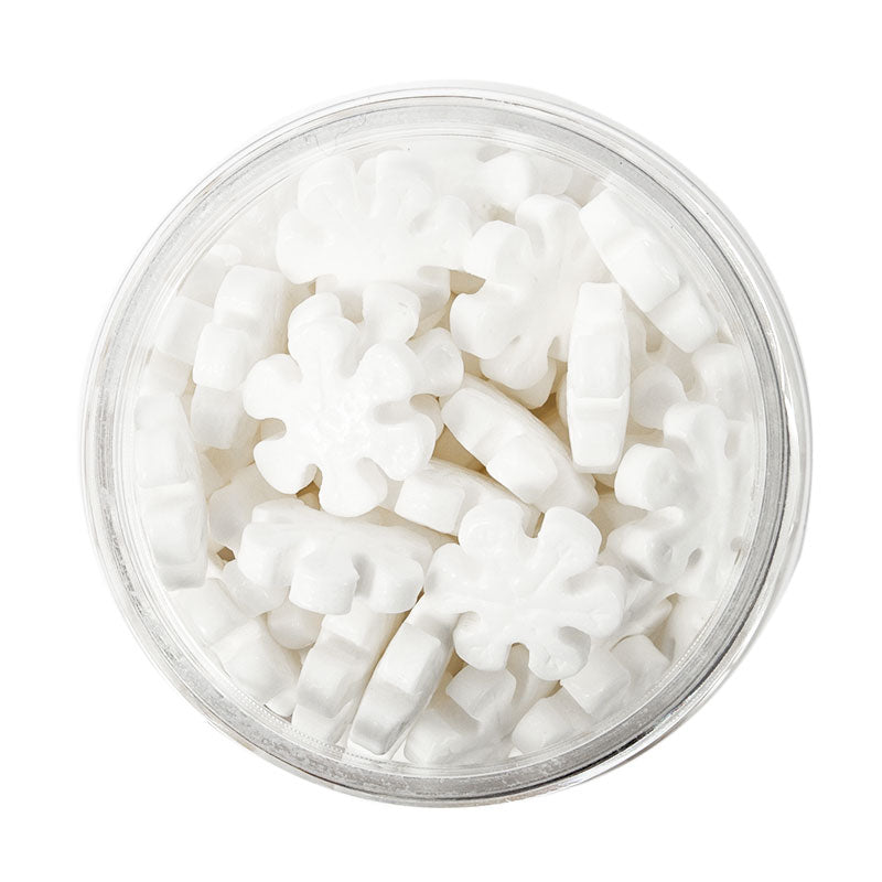 Image of container of white snowflake shaped sprinkles for cake or cookie decorating. 
