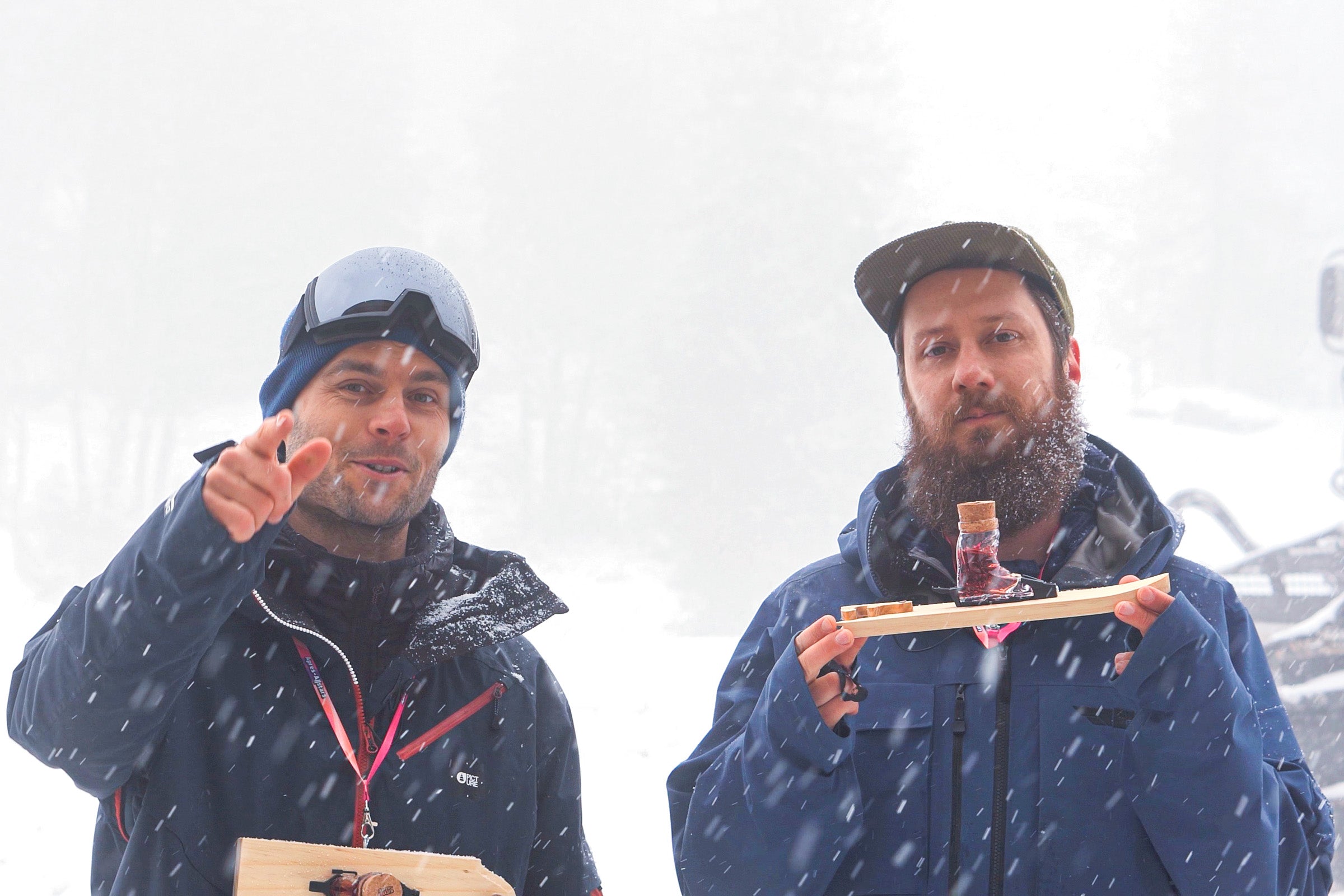 Tobi & Michi: Apres Allstar founders standing outsided while it is snowing and showing off the mini ski product.
