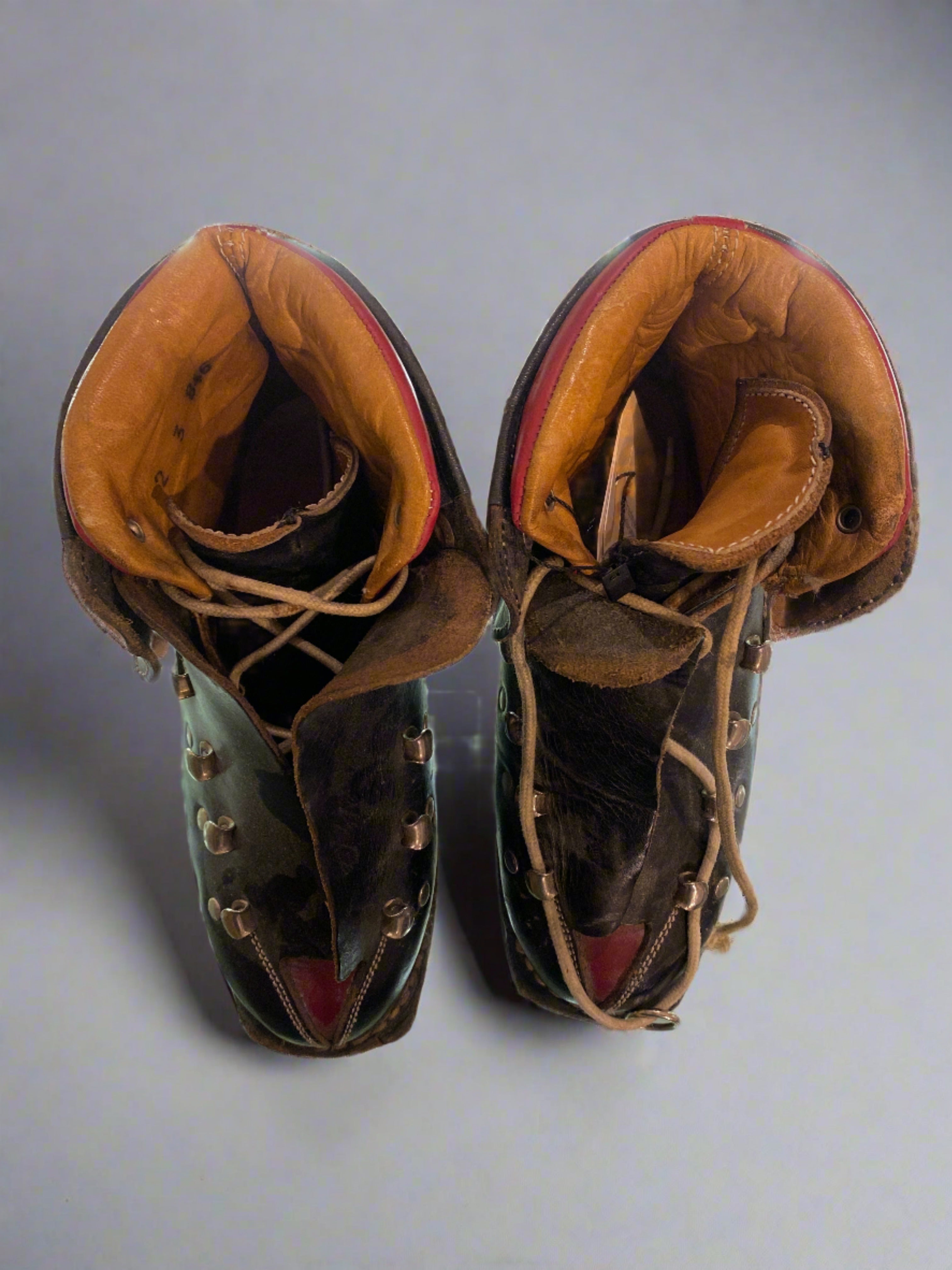 Vintage Koflach Snow Star black and red child's leather ski boots with double laces. top down view