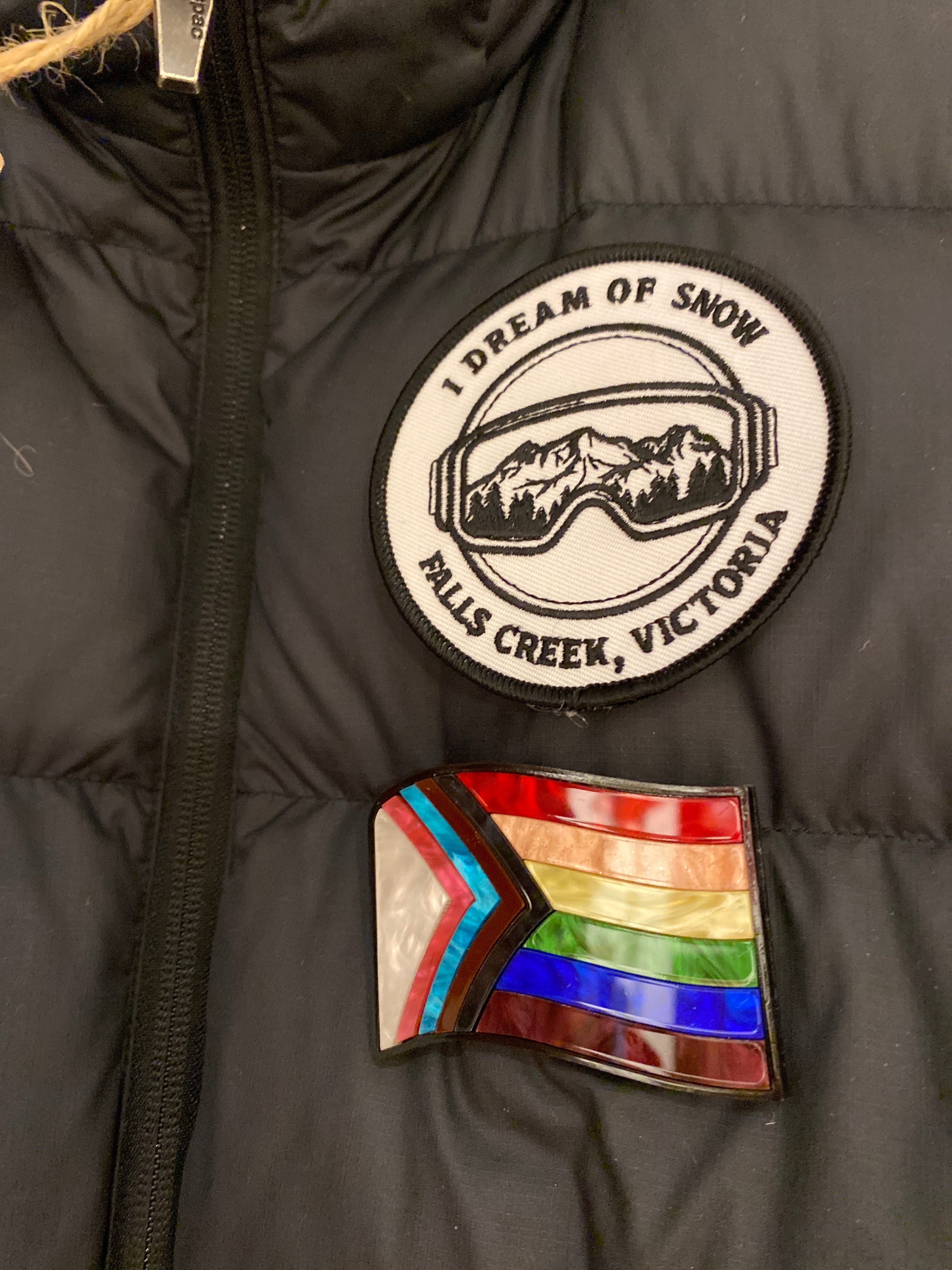 Rainbow Pride Flag Brooch with Magnet on Black Vest. Close up