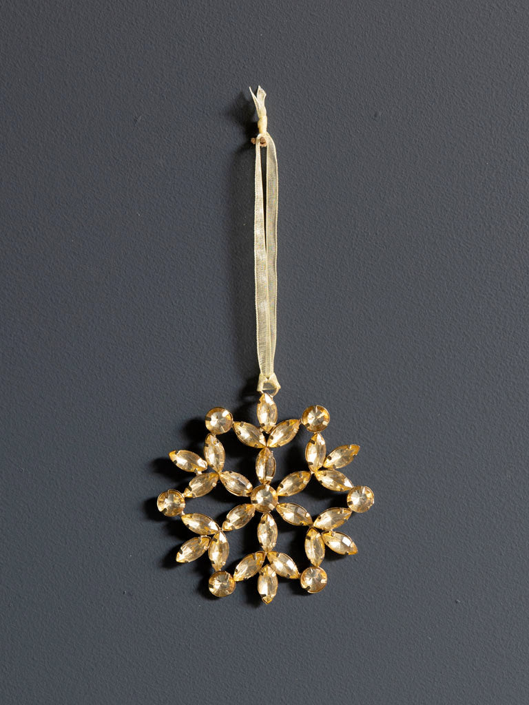 Golden Bead Snowflake, against dark background