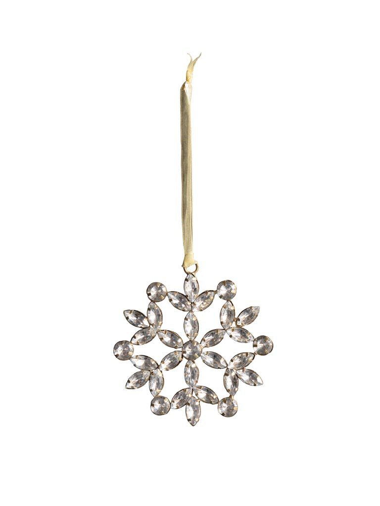 Hanging flowery silver snowflake against white background