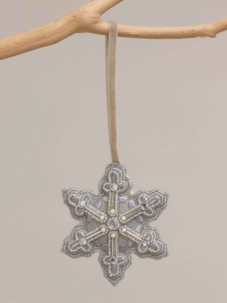 Hanging silver beaded snowflake 4cm, hangin from a branch