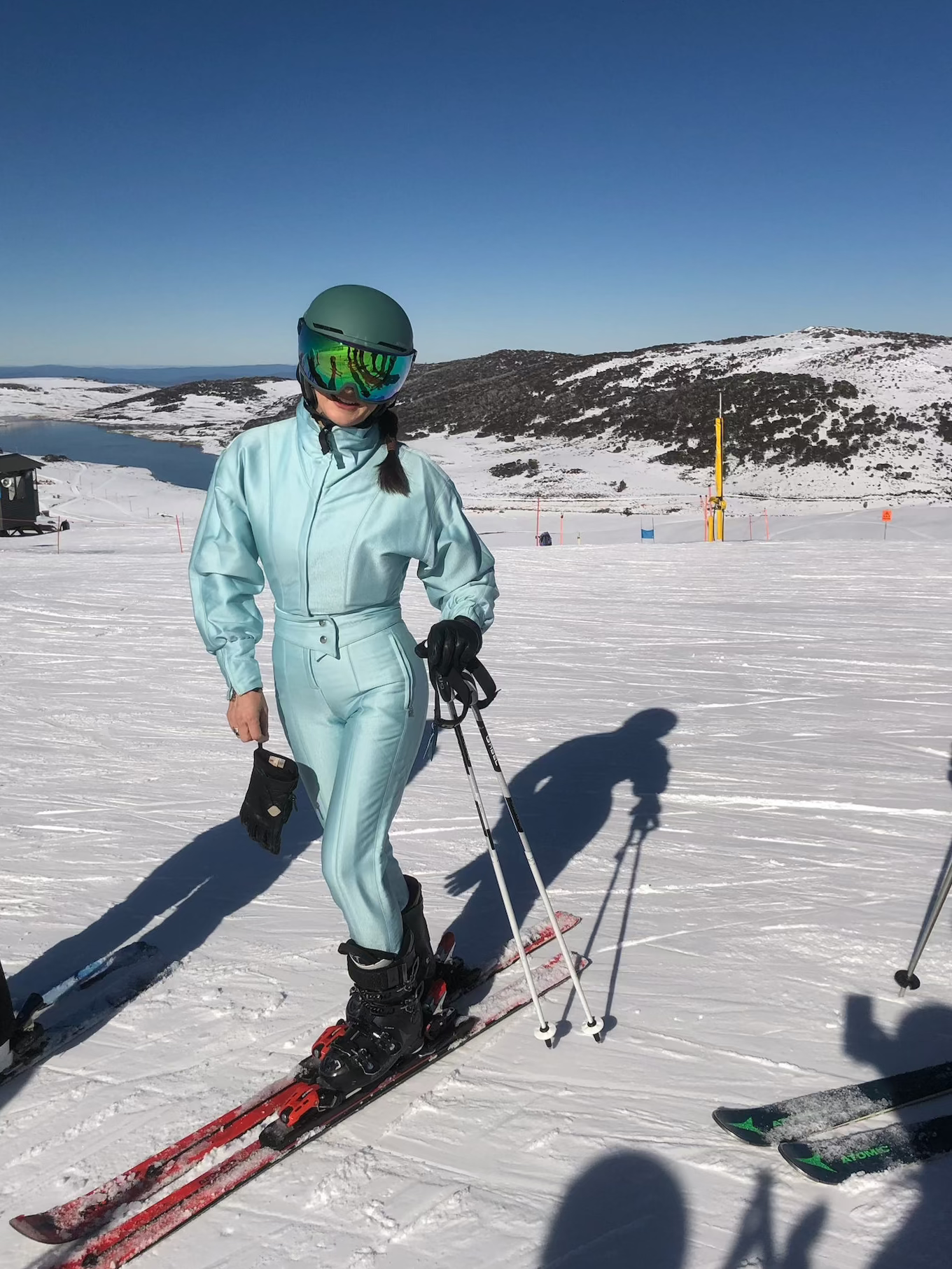 Woman wearing the Bogner suit skiing on a blue sky day 