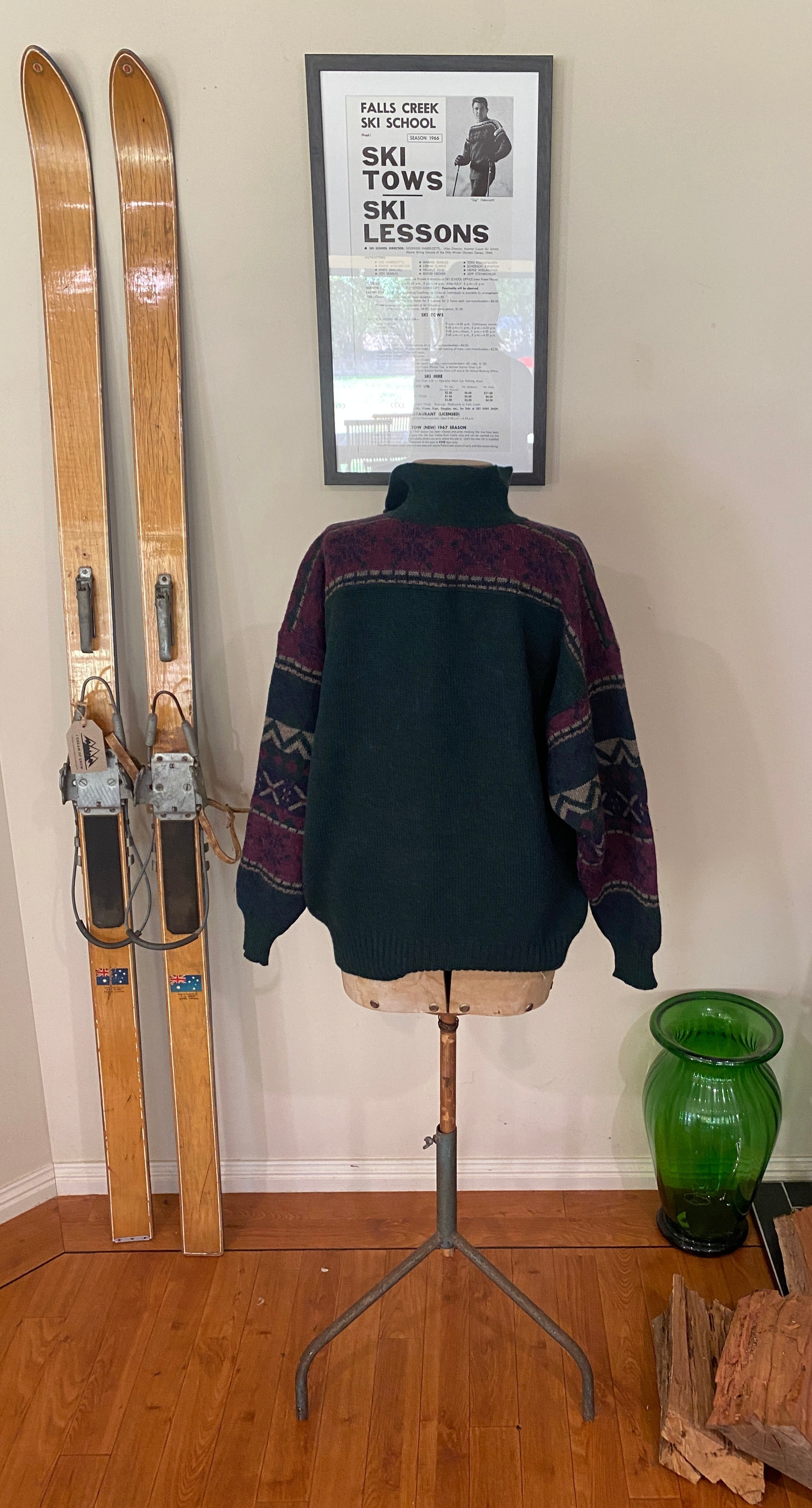 Vintage Bogner forrest green woollen jumper with skier and a cliff on the chest and a navy, purple and grey geometric pattern across chest & arms.  Rear