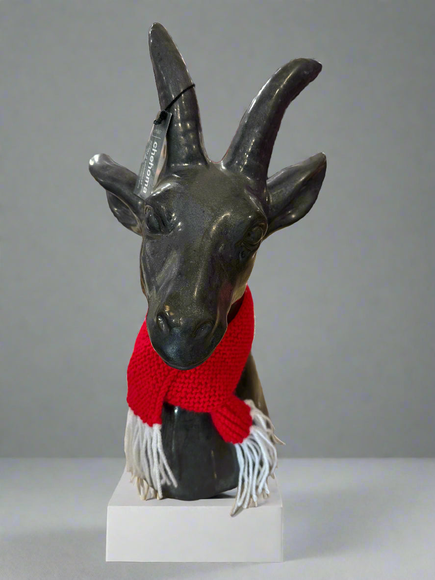 Chehoma Silver Goat Statue modelling the red wool dolls scarf with white tassels. Goat Statue sold separately.