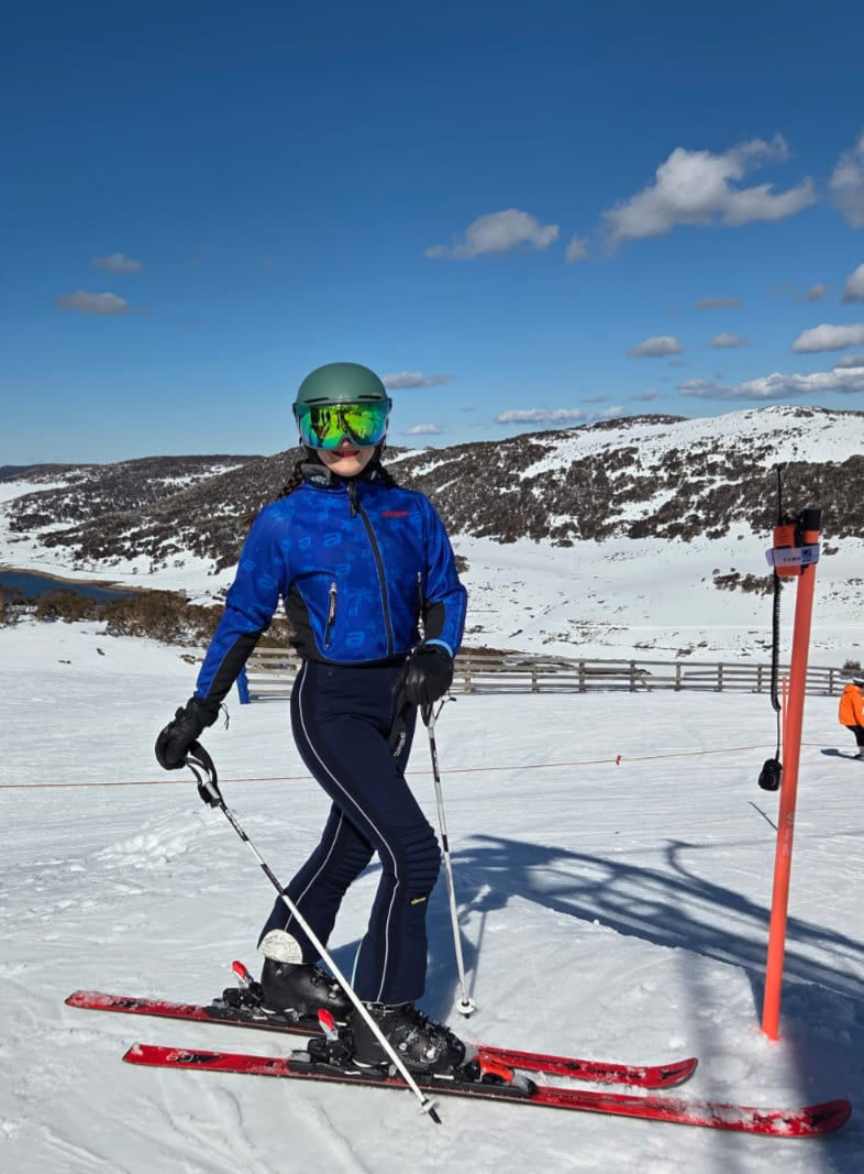 Women on skis wearing a Early 2000's Fall Creek Race Club Padded Race Shell  Jacket and vintage padded race pants