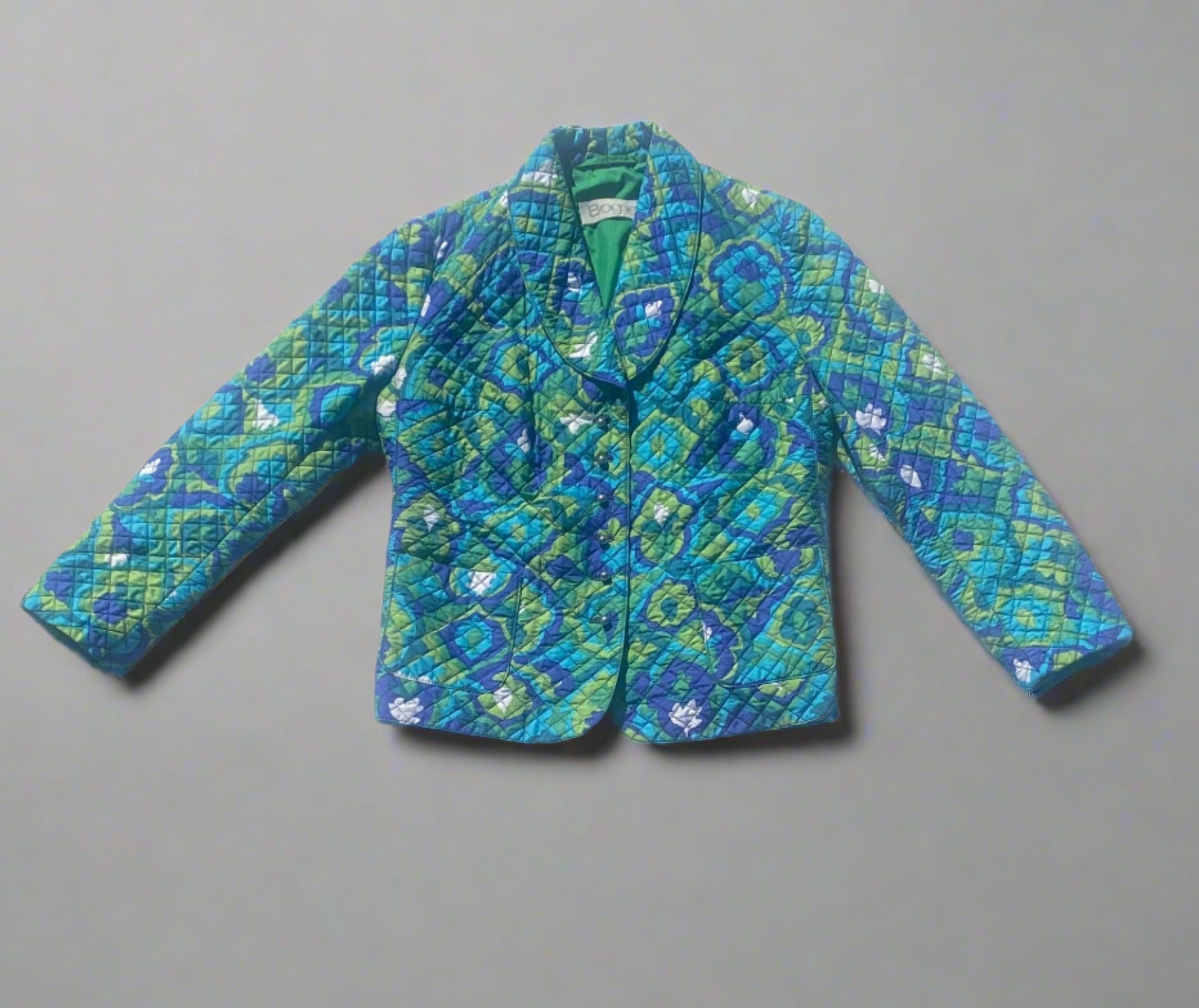 Vintage Bogner Vintage Bogner green, navy, teal blue quilted jacket with a floral pattern. Front view