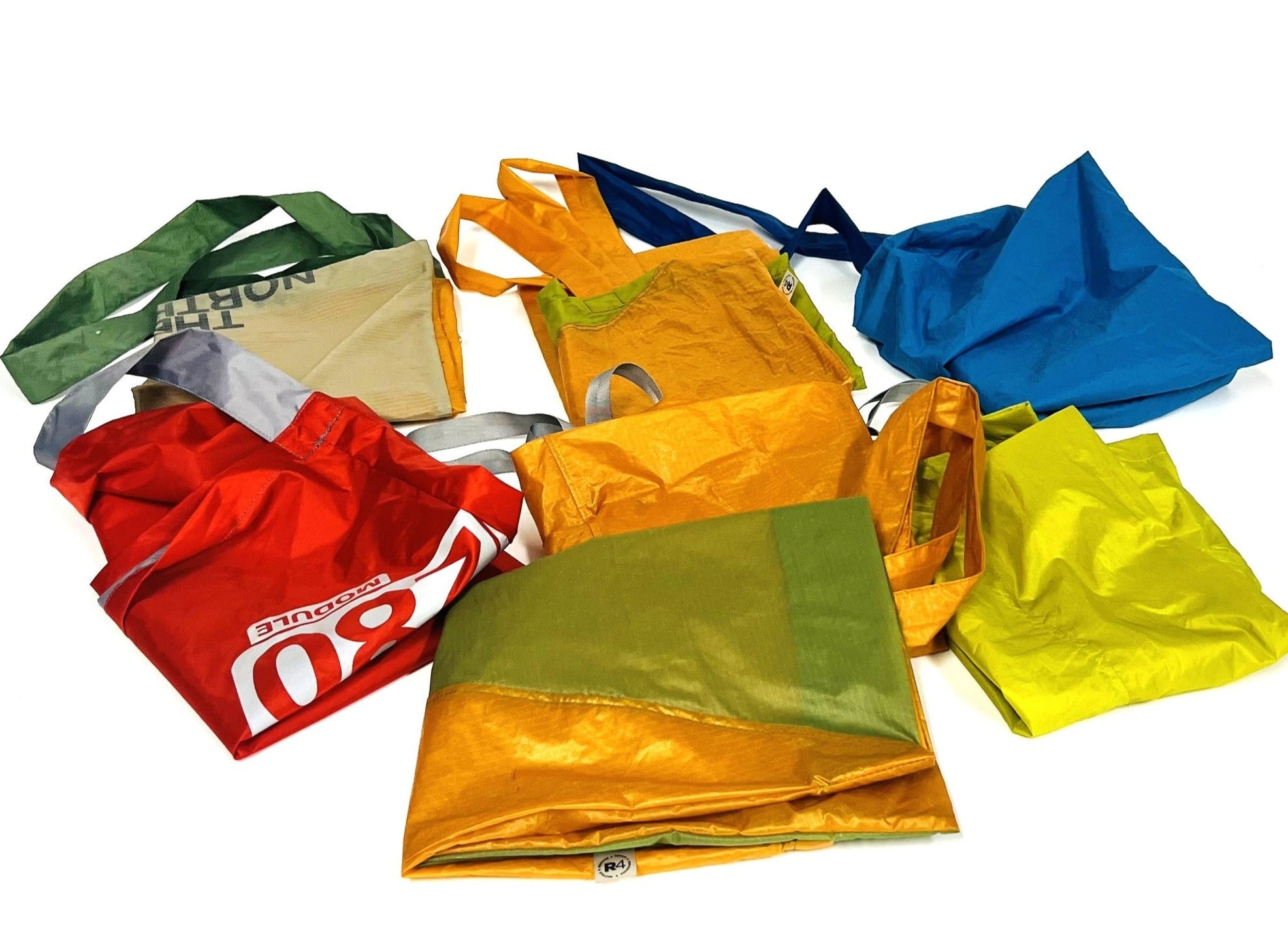 Collection of colourful R4 Market Bags on a white background