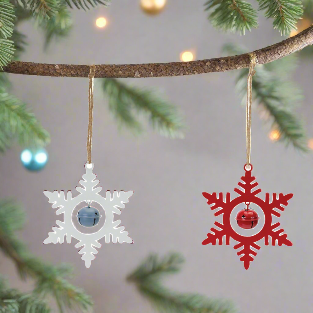 White & Red metal snowflake hanging ornaments with bells, hanging on a Christmas tree.