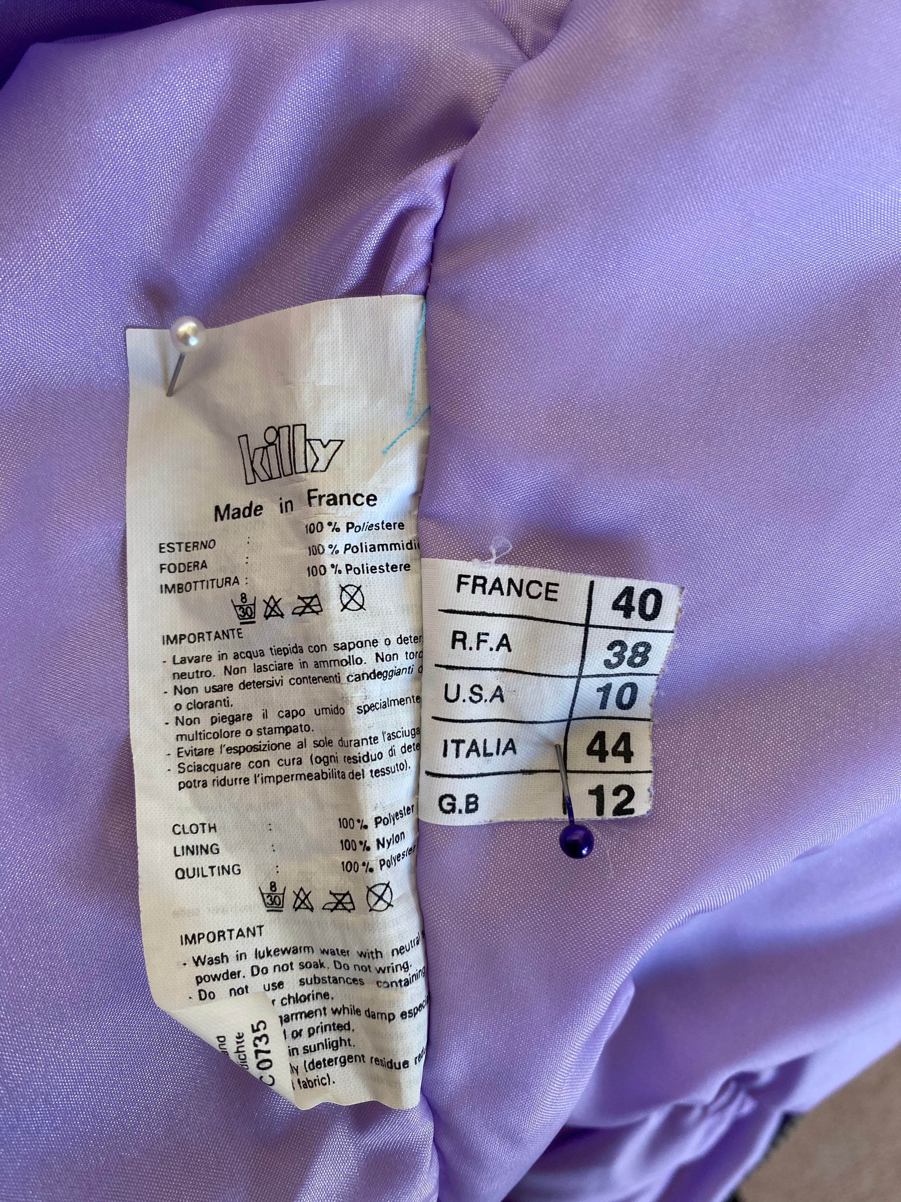 Killy purple one piece ski suit with belt and hood that folds away into the collar. Label