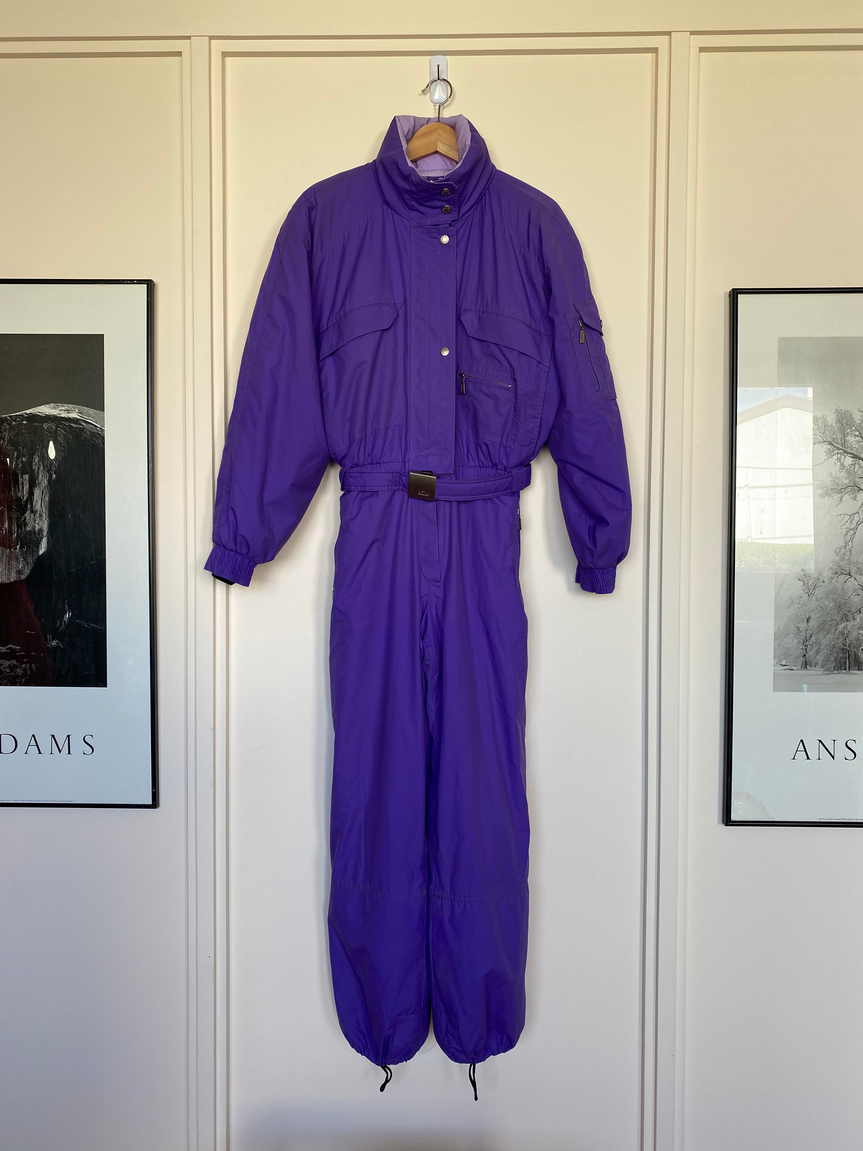 Killy purple one piece ski suit with belt and hood that folds away into the collar. Front