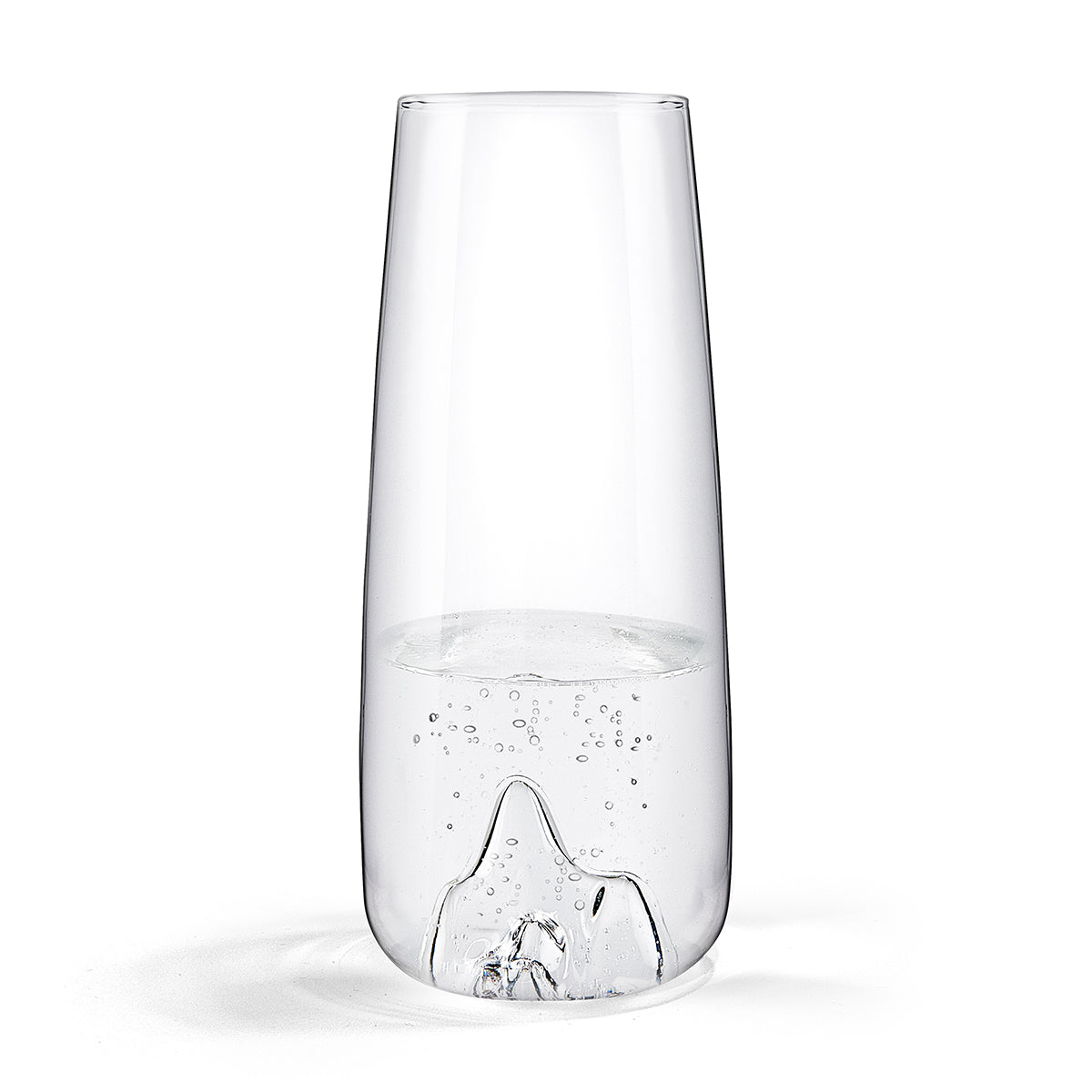 Image of a glass carafe with the shape of a mountain peak indented into its base. The carafe is filled with sparling water. Set against a white background.