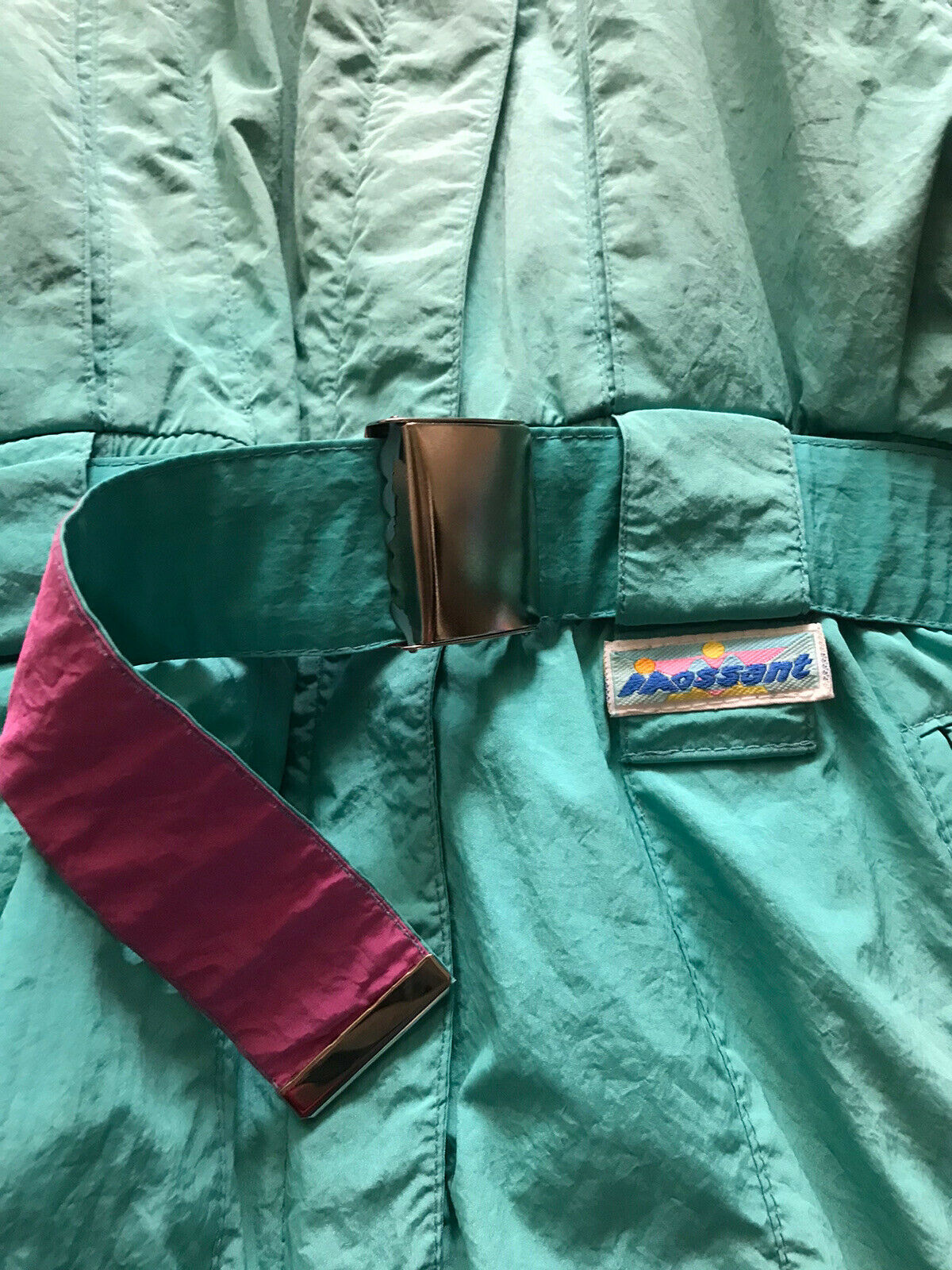 Vintage Mossant teal green one piece ski suit, with pink, yellow and purple ribbon stripes. Belt