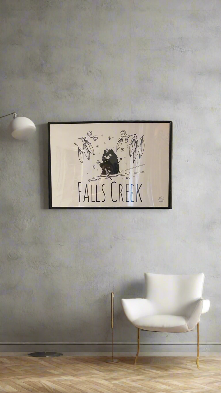 Skiing wombat under snow gum leaves and snowflakes with the words Falls Creek printed underneath the image, in a thin black frame