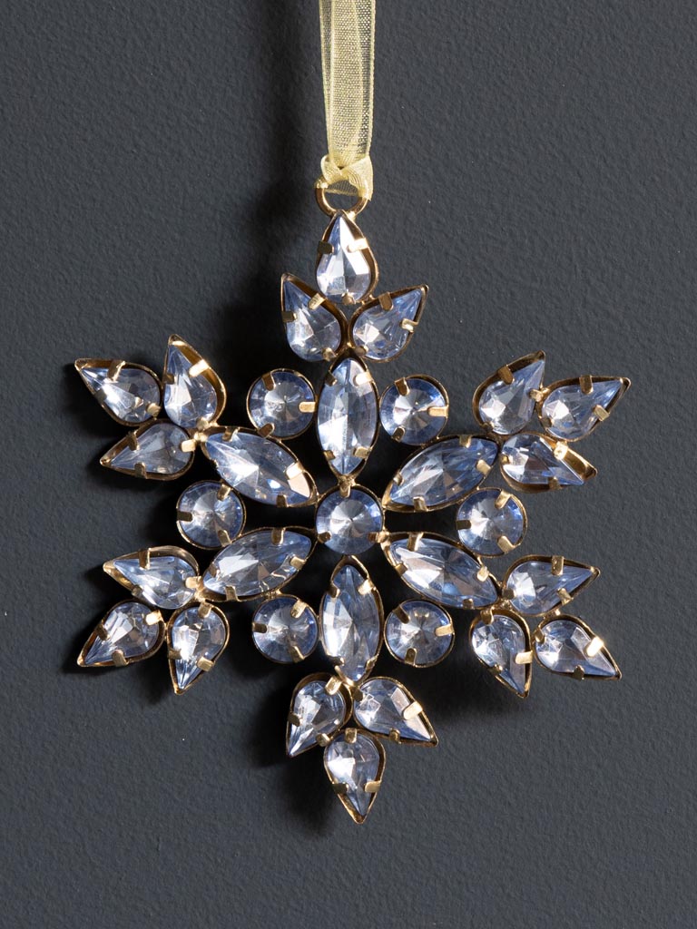 Silver Blue bead snowflake hanging ornament against a dark background. Close up