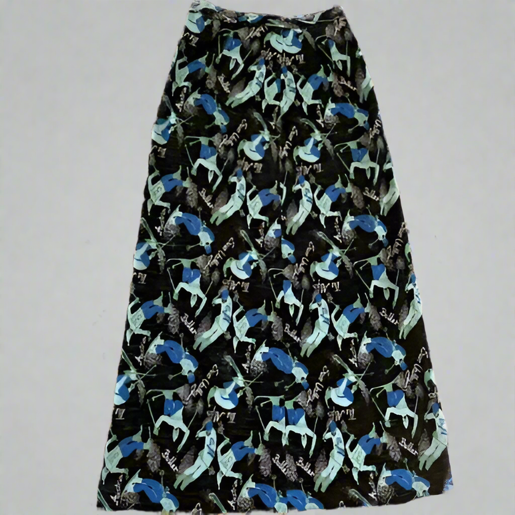 "Mt Buller" A-line full length skirt with side zip. Size 14 (more like modern day 8-10). Pattern is teal and blue skiers on a black background with the words Buller, Sun Valley, The Alps, Austria printed in white. 