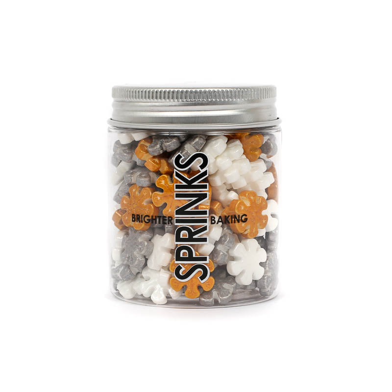 Image of a container of white, silver & gold snowflake shaped sprinkles for cake or cookie decorating viewed from the front with brand label visible 