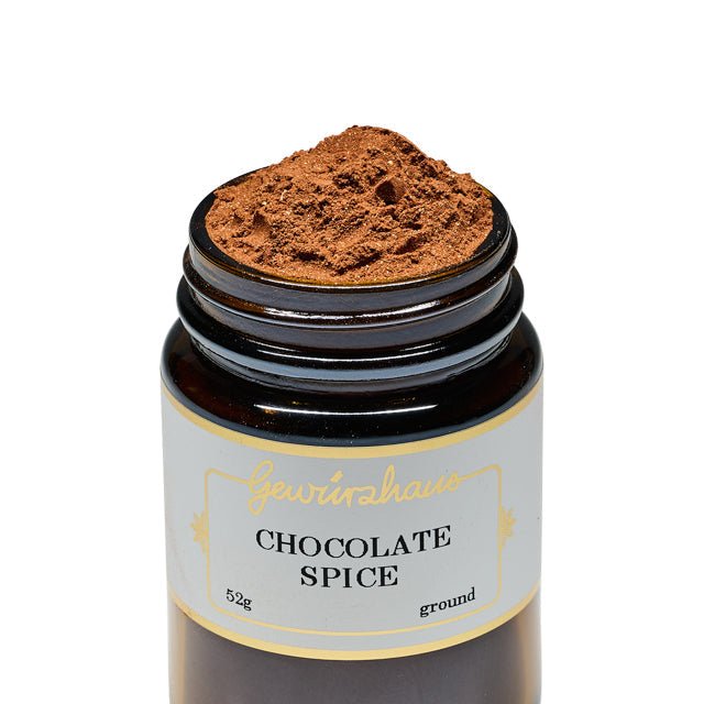 Photo of a jar of Gewürzhaus Chocolate Spice, lid off and spice high in the jar. Shown against a white background. 