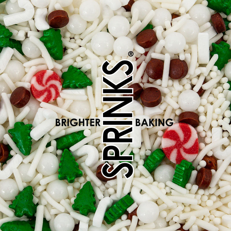 Image of white snowflake, green tree, red & white candy, white ball and brown circular shaped sprinkles for cake or cookie decorating spread out. Brand logo imposed over the too