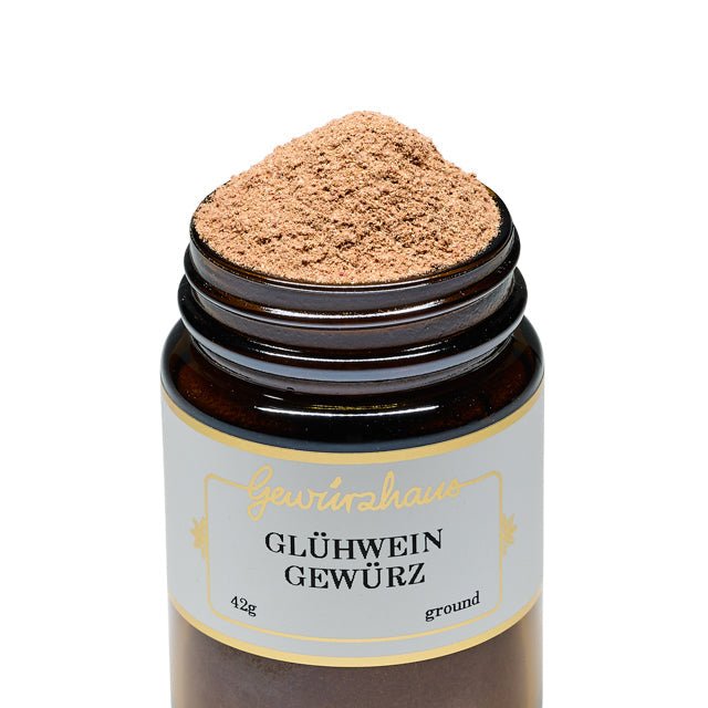 Photo of a jar of Gewurzhaus Gluhwein, lid off and spice high in the jar. Shown against a white background. 