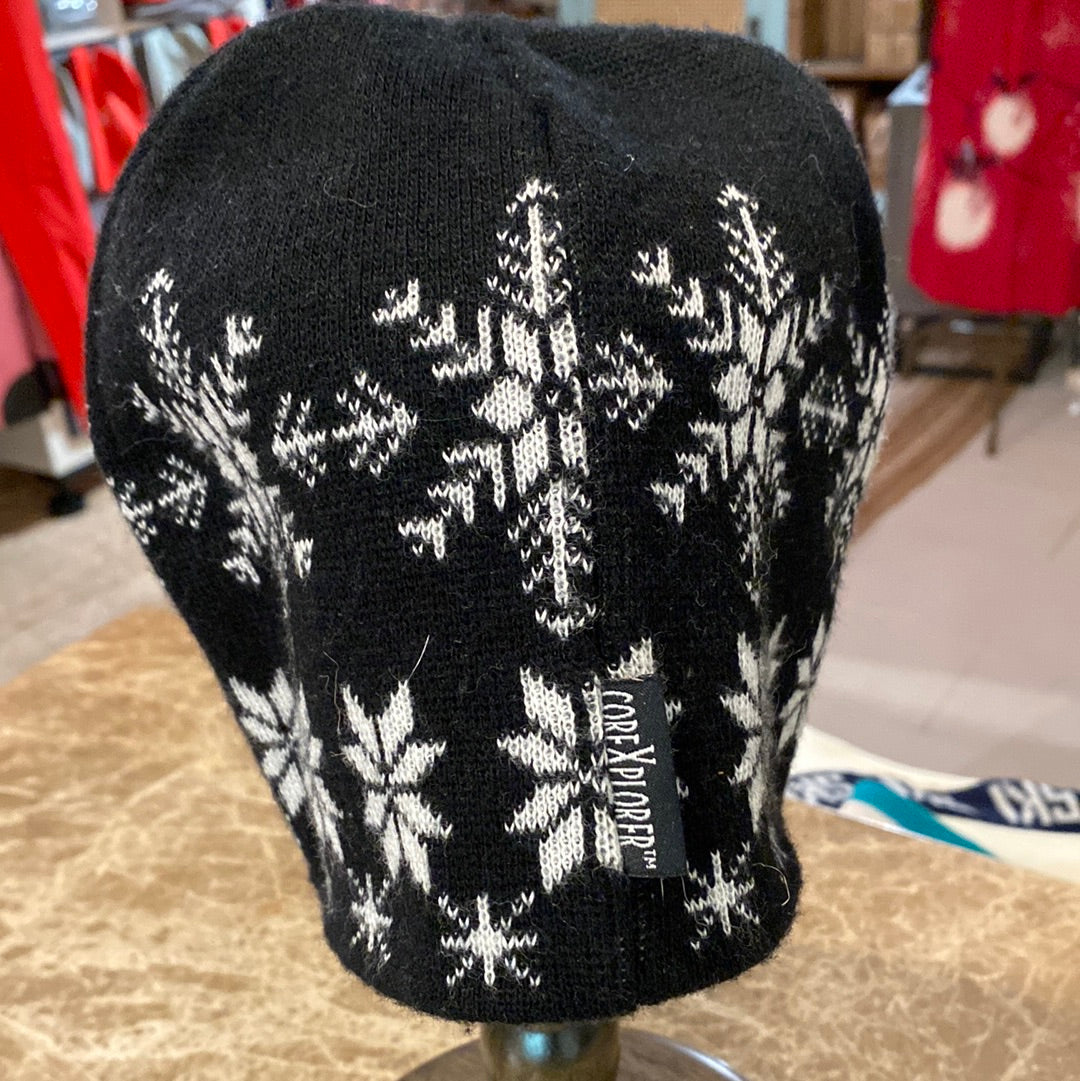 Black & White Snowflake Pattern Beanie shown on hat stand, with brand showing