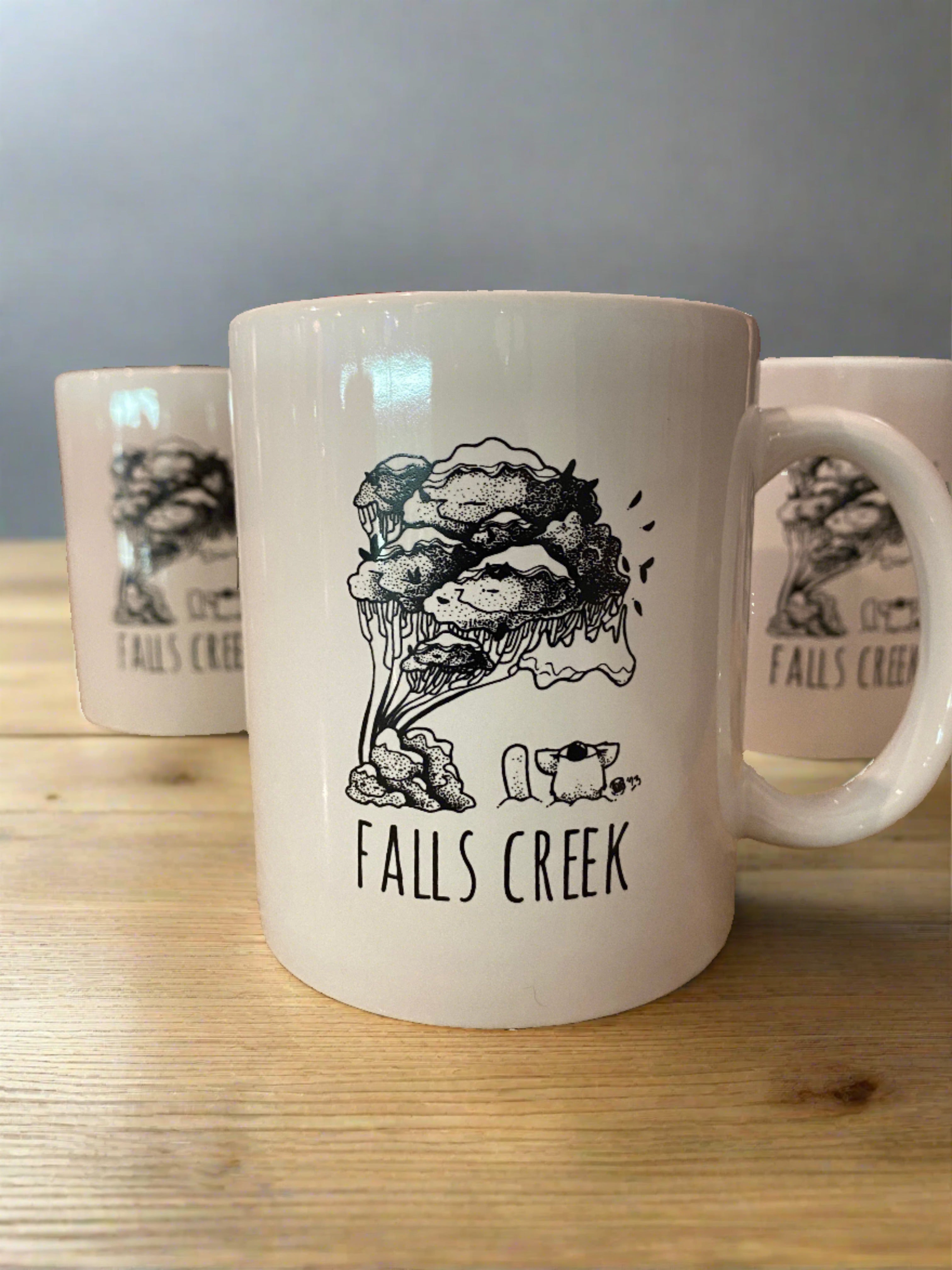 Falls Creek Agent K Ceramic Mugs. Close up of 3 mugs on a wooden table top
