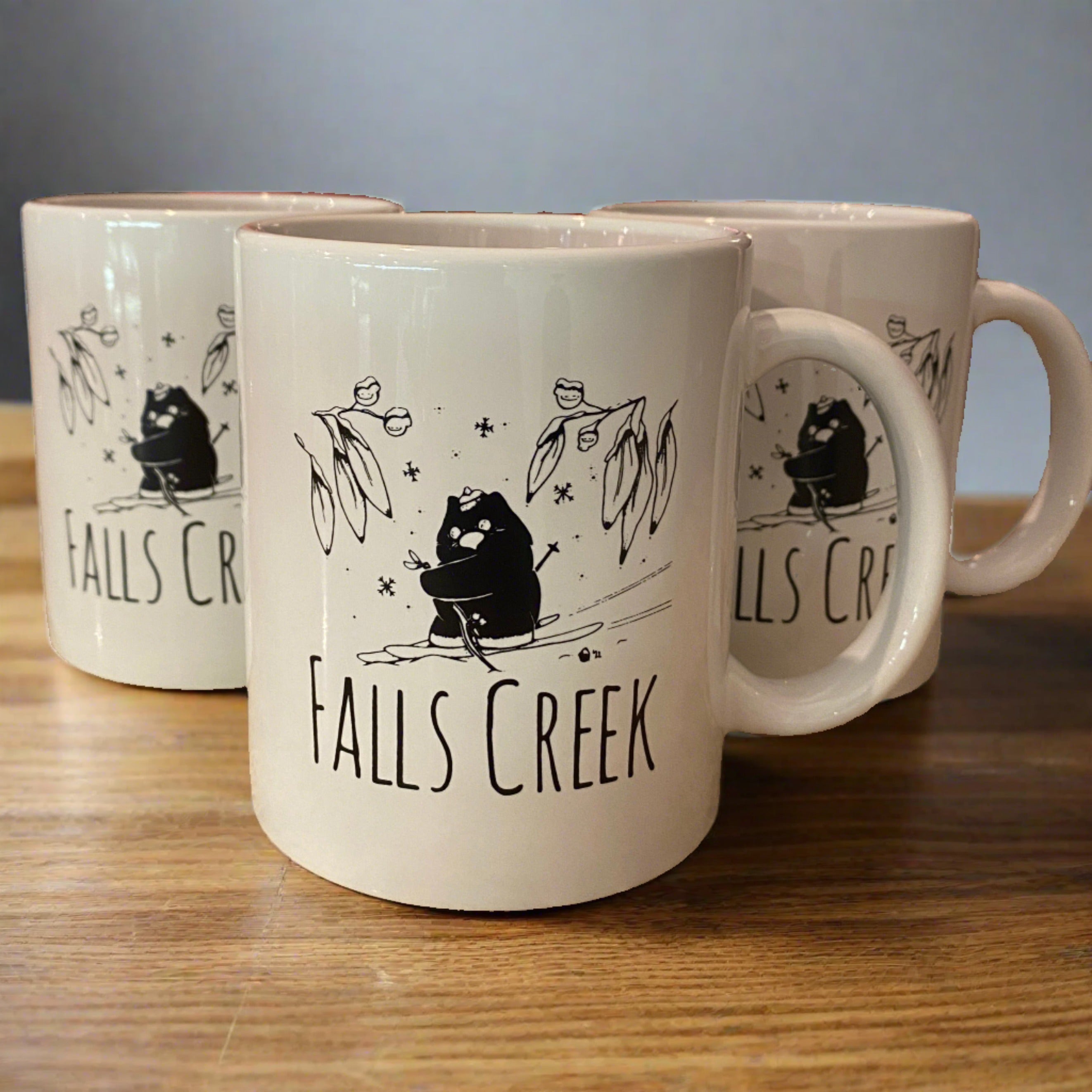Falls Creek Agent W Ceramic Mugs. 3 Mugs on a wooden table top