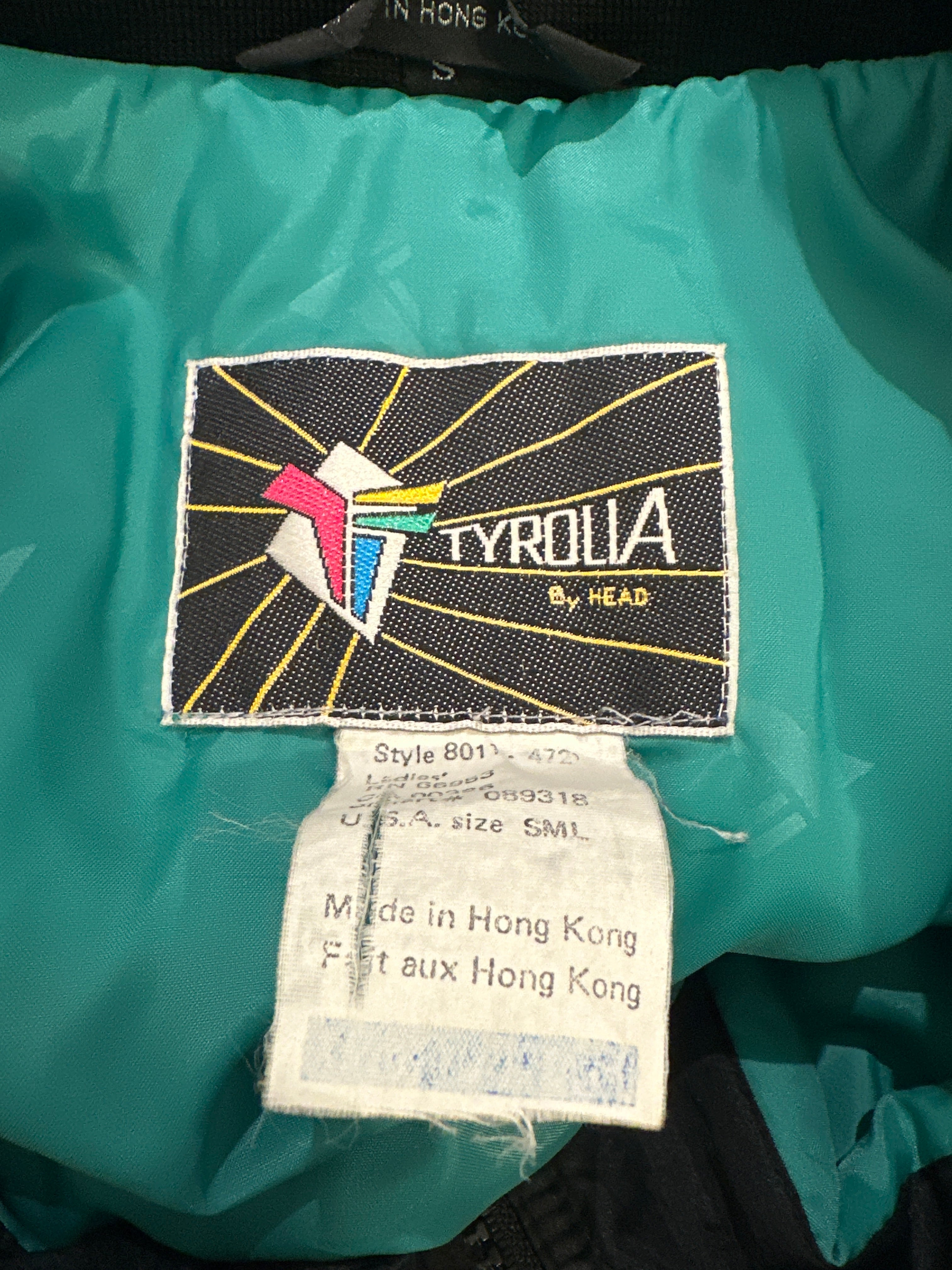 Tyrolia by Head Black & Green Asymmetrical Stripe 1-Piece Ski Suit. Brand & Size Label