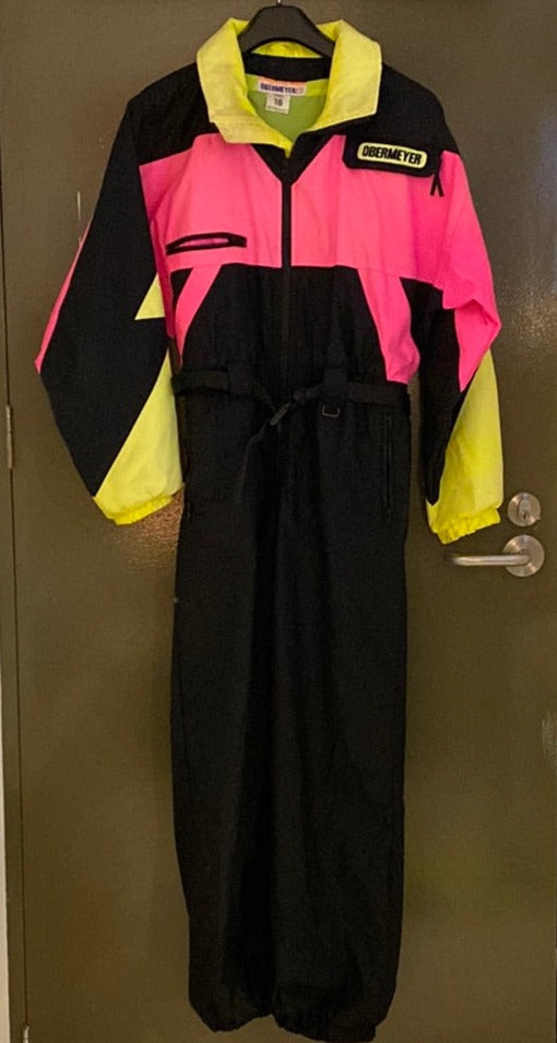 Vintage Obermeyer Black Pink Yellow One Piece Ski Suit, front