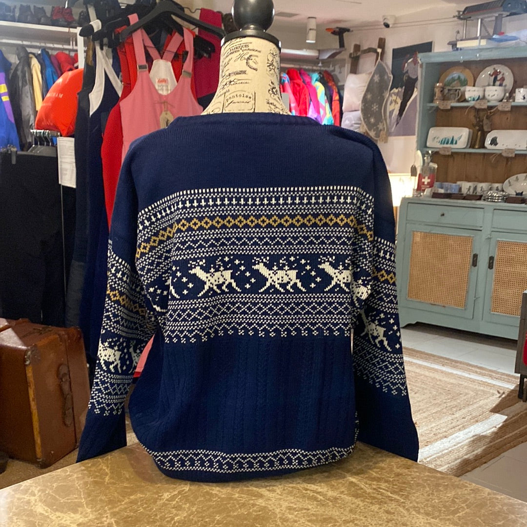 Blue vintage Botany 500 Ski Jumper with reindeer pattern in white and tan featured on a navy blue background. Back view of jumper