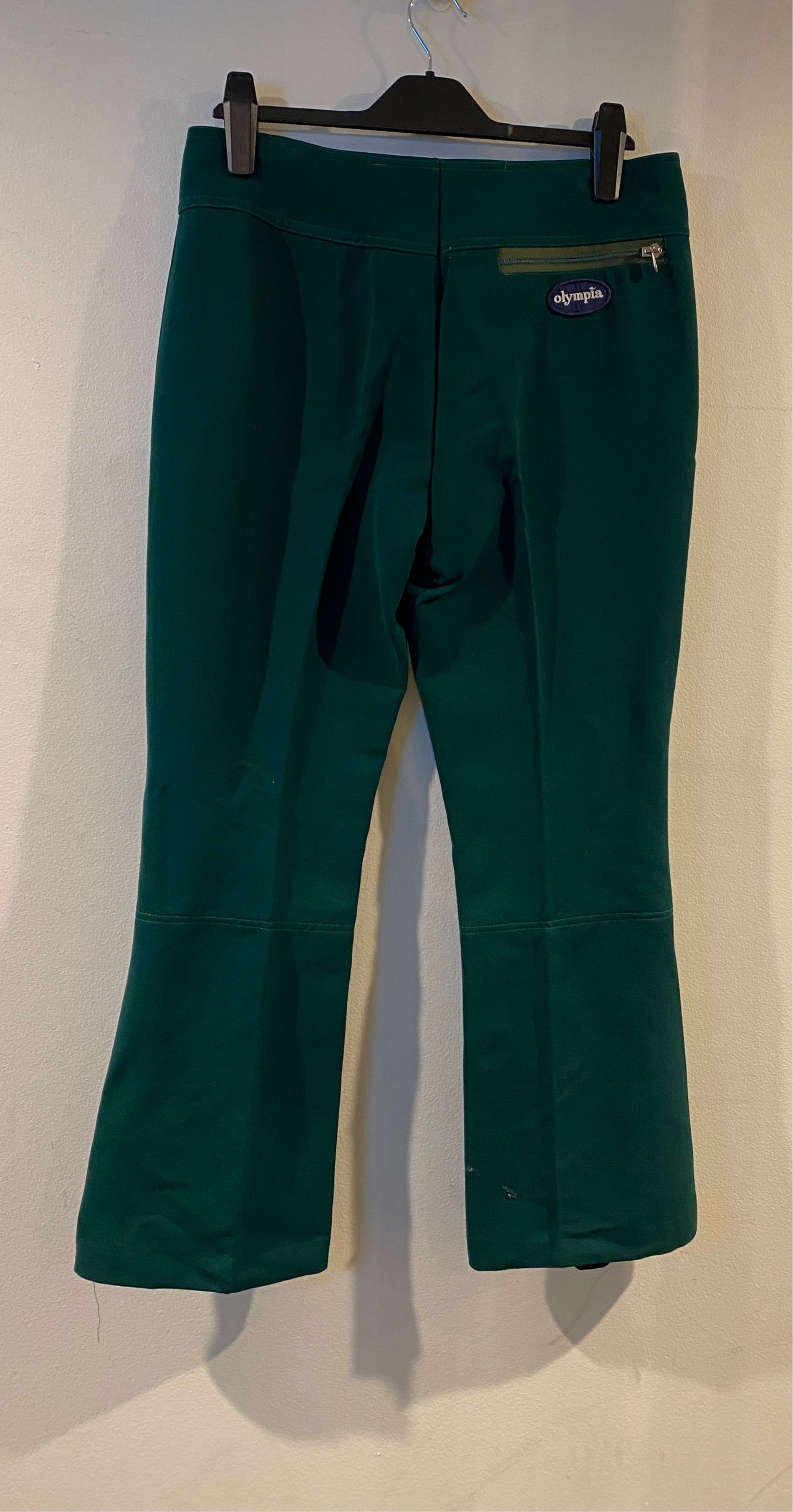 Vintage Olympia green ski pants. hanging, rear view