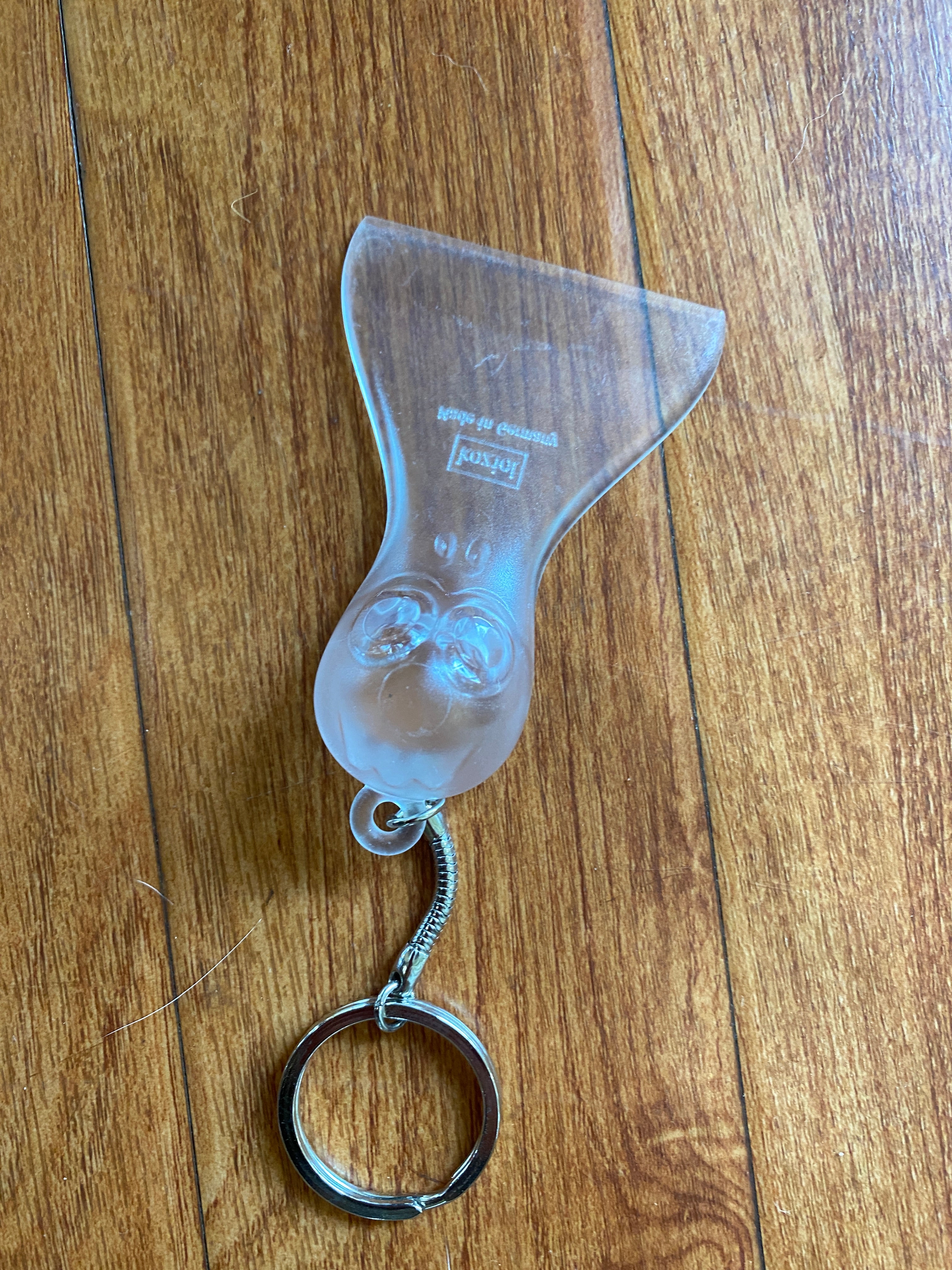 Clear Plastic 'Yeti' Mini Ice Scraper, with a large eyed face on the grip of the scraper viewed from above