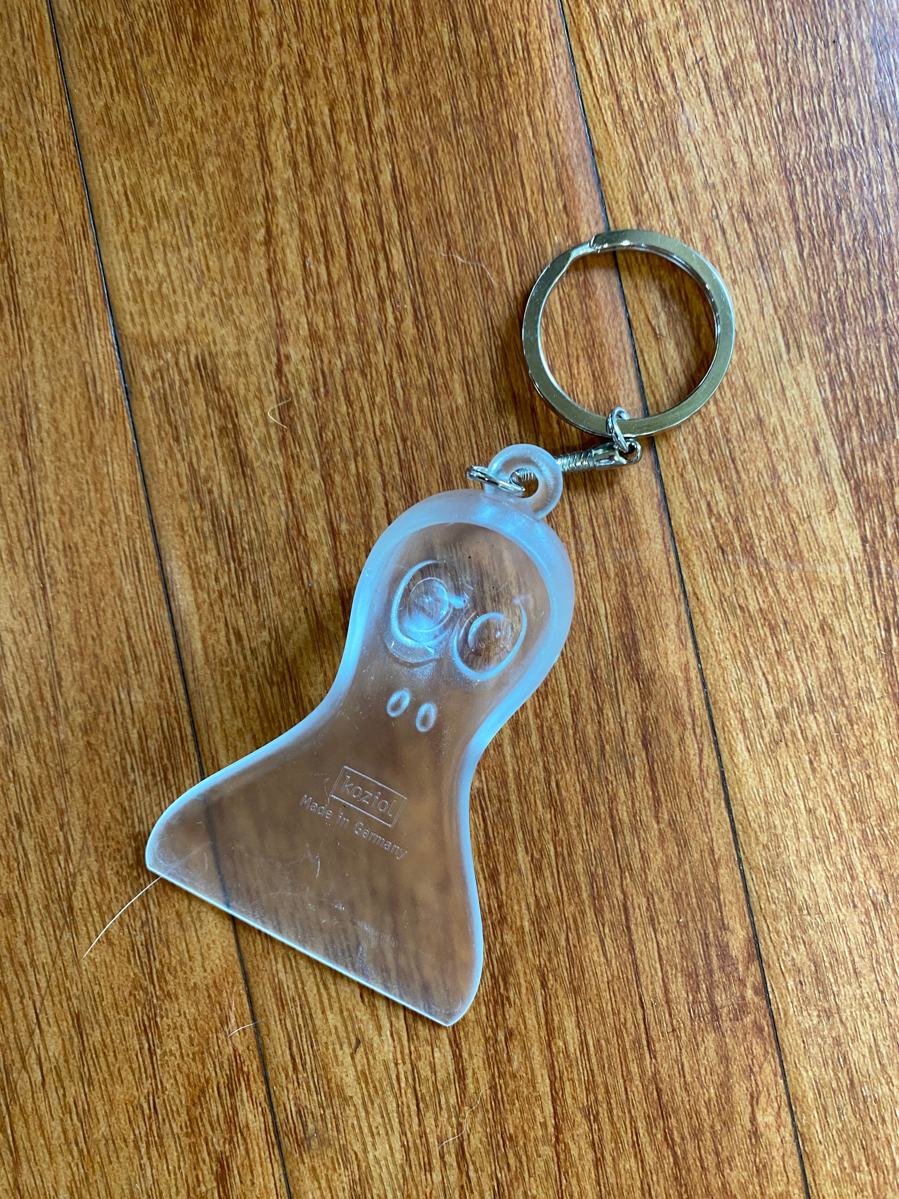 Clear Plastic 'Yeti' Mini Ice Scraper, with a large eyed face on the grip of the scraper viewed from the back