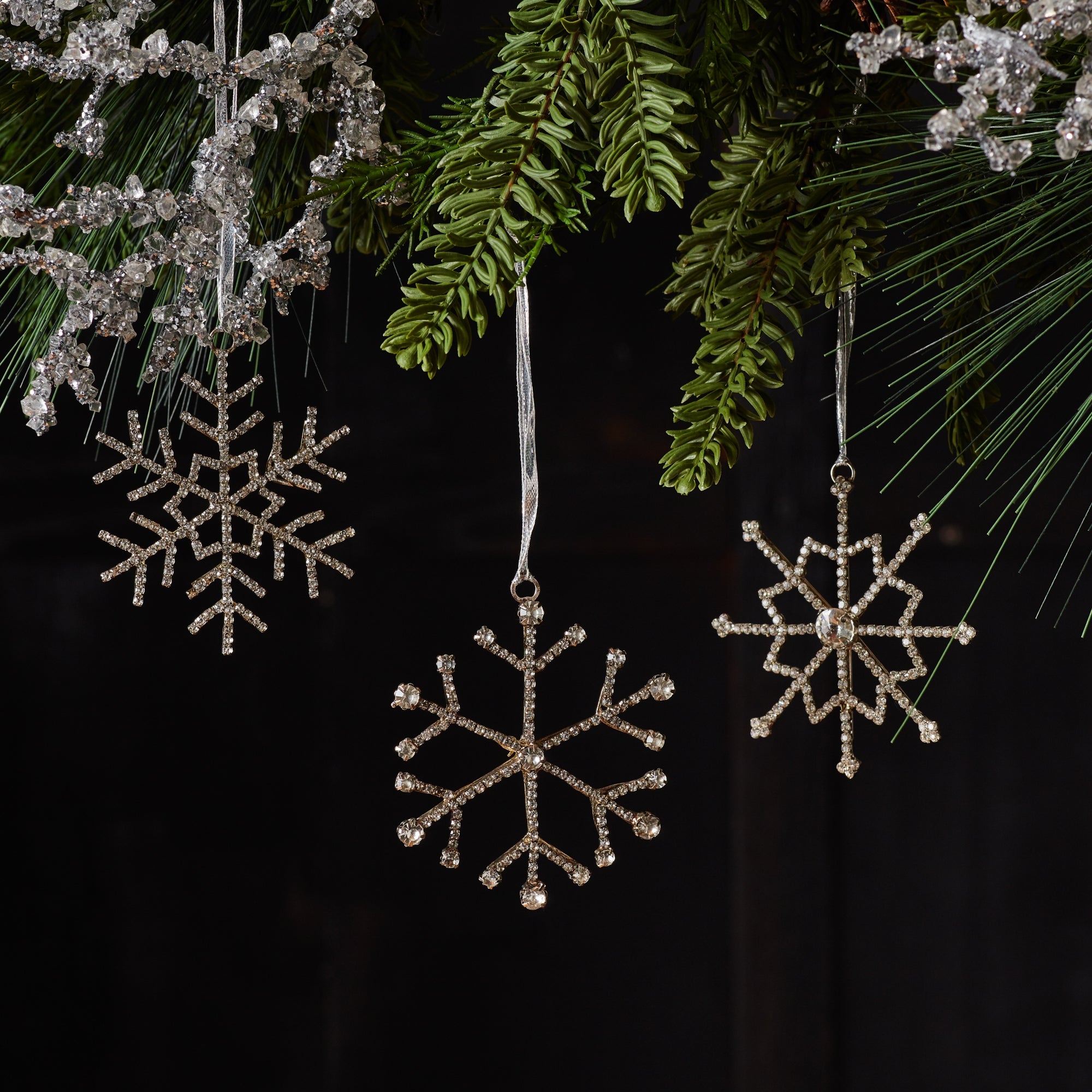 3 Jewel Snowflake steel and glass hanging ornaments, hanging from Christmas tree branches