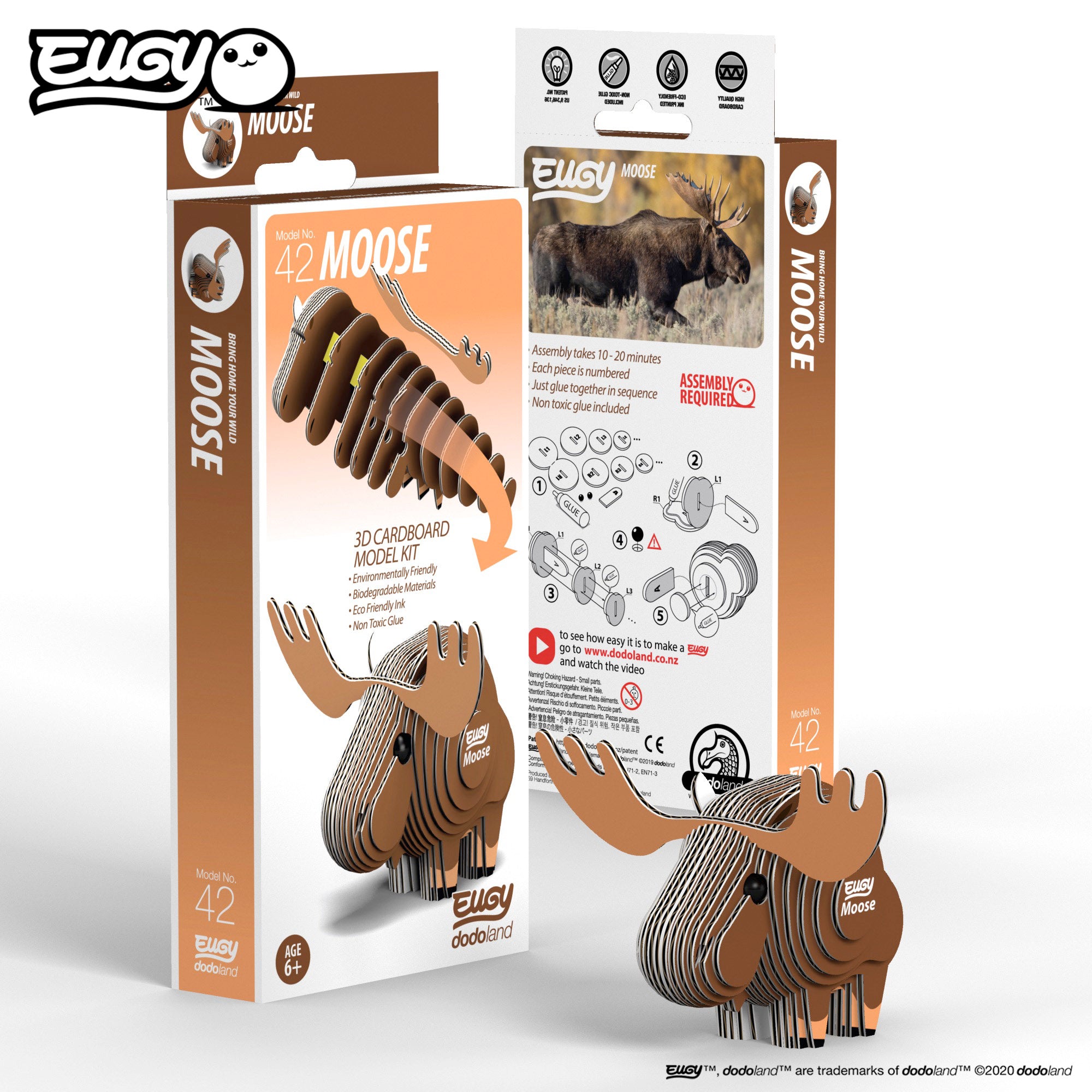 Image of an EUGY Moose, looking left in front two EUGY Kangaroo Boxes, 1 showing the front cover and the other showing the rear of the box, against a white background