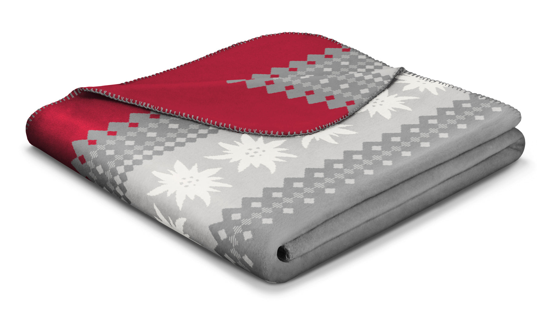 Folded Grey, white and red Edelweiss  blanket patterned with white and grey flowers. Pattern colour scheme alternates on the other side of the blanket.