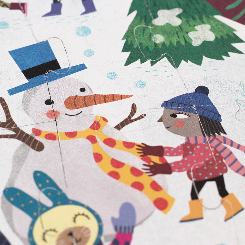 Image shows a close up of the winter puzzle with images of people and animals enjoying winter snow activities.
