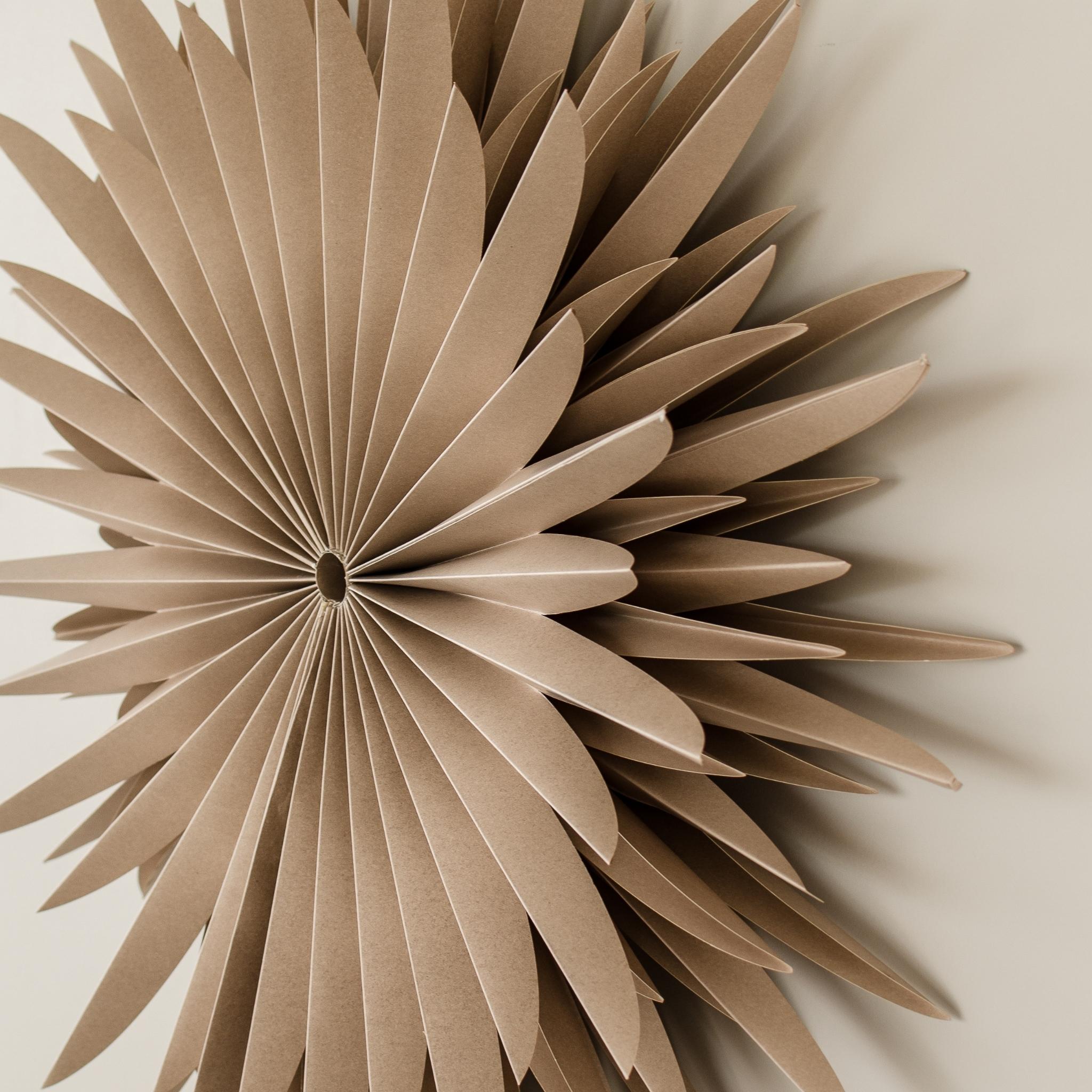 Almond Latte paper Star wall hanging in 70cm diameter hanging on a beige wall