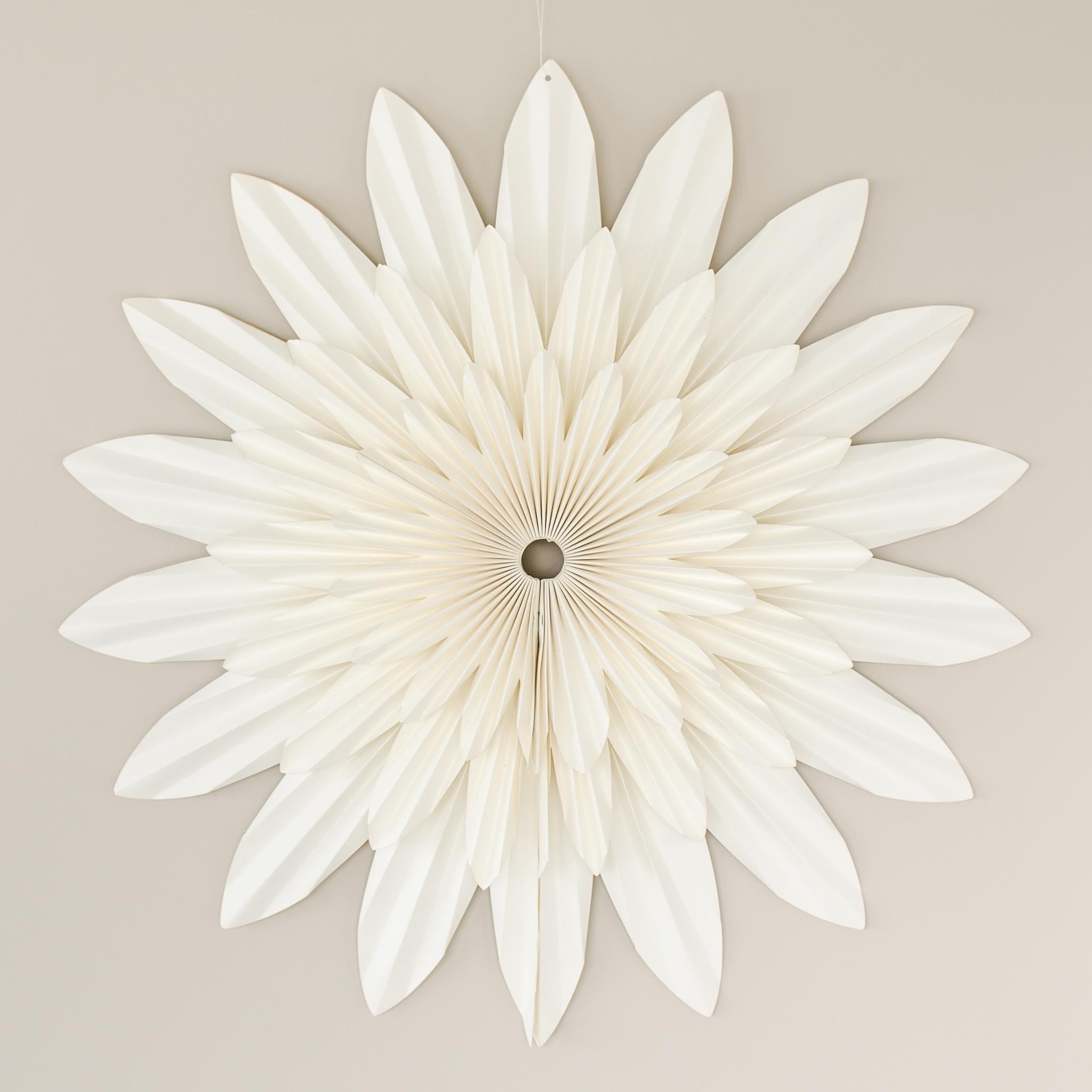70 cm Off-white paper flower wall hanging, hanging on a beige wall 