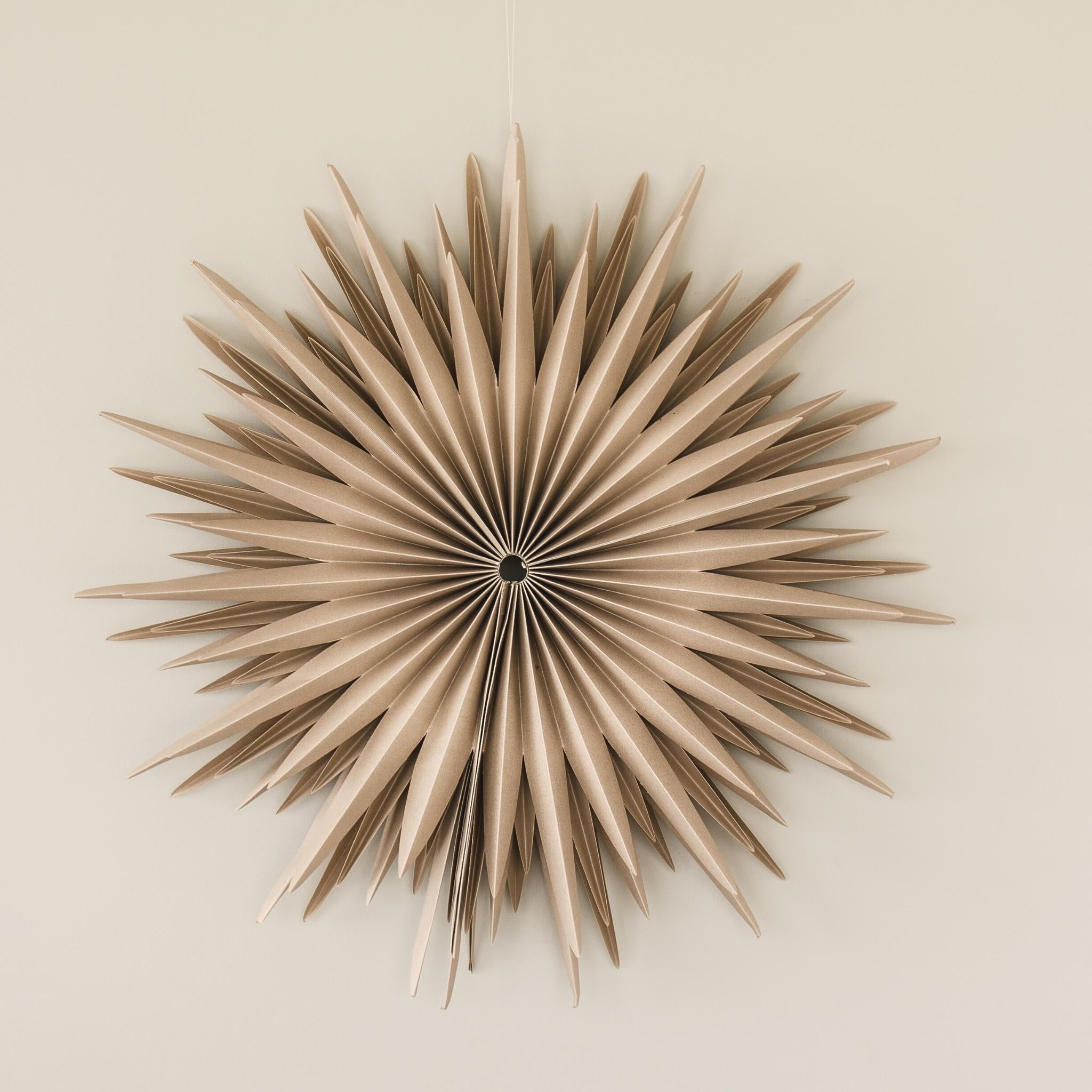 Almond Latte paper Star wall hanging in 50cm diameter hanging on a beige wall
