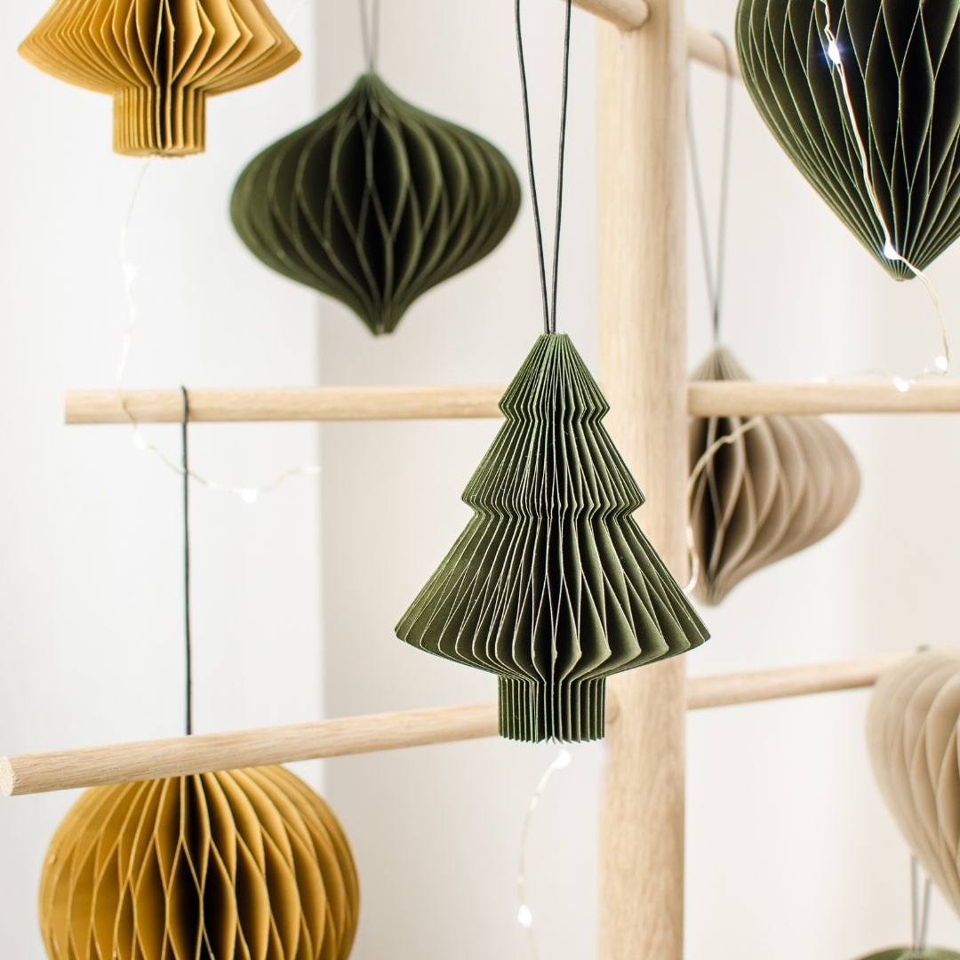 Variety of Olive Green, Rust and Linen Coloured Paper Christmas Ornaments hanging from a wooden tree frame, with an Olive Green tree ornament in the centre