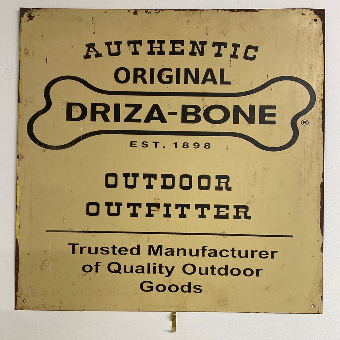 Vintage Driza-Bone advertising sign. Enamel front with the word 'authentic original Driza-bone Est.1898. Outdoor Outfitter. Trusted Manufacturer of Quality Outdoor Goods' & logo printed on a rusted square tin base. Rust and enamel chipping visible at edges. All 4 corners have hanging holes drilled.