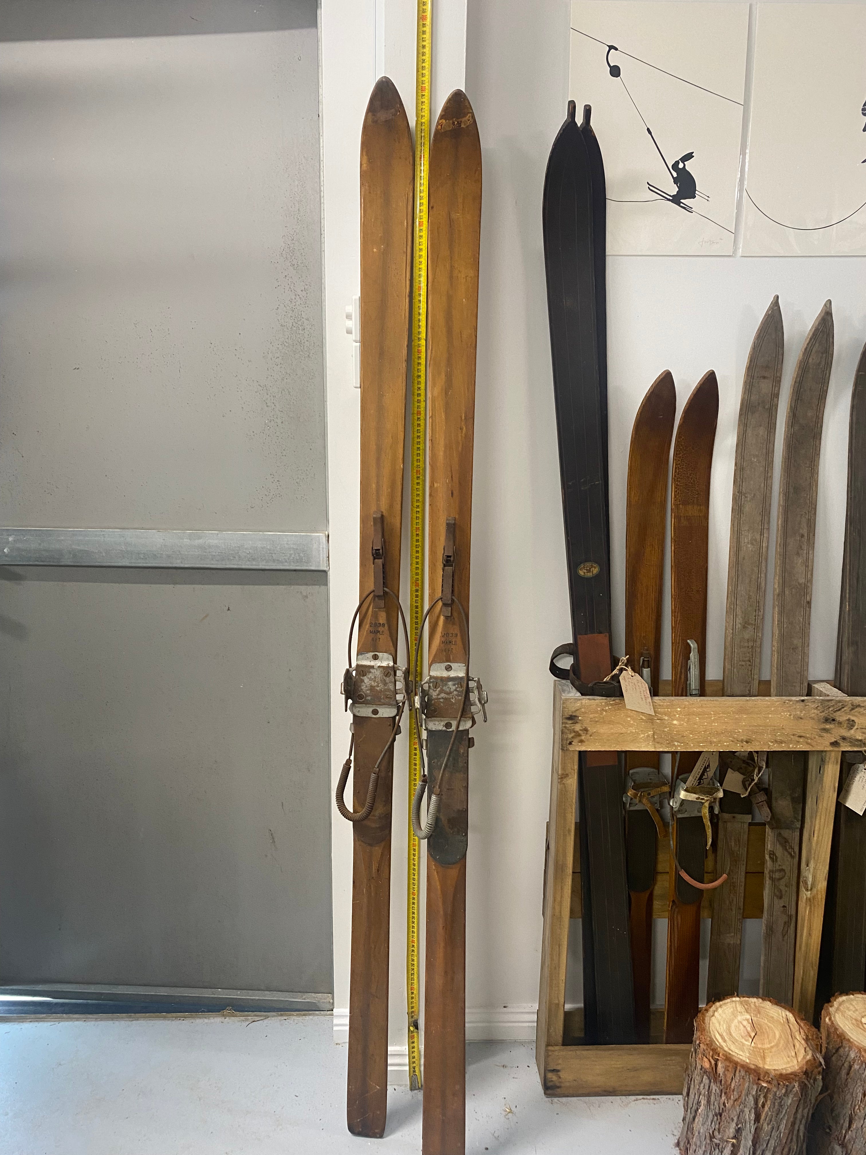 Full length front view: Peterborough Wooden Skis with metal ski bindings 