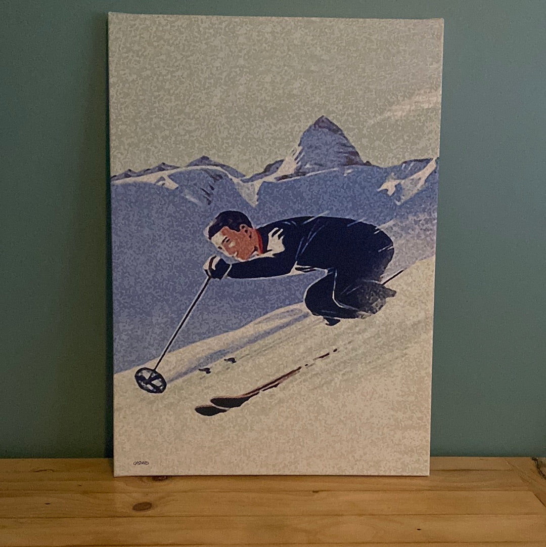  a man in blue suit skiing downhill, with shaded mountains in the background below a green-blue tinged sky. Leaning against a green wall on a timber table